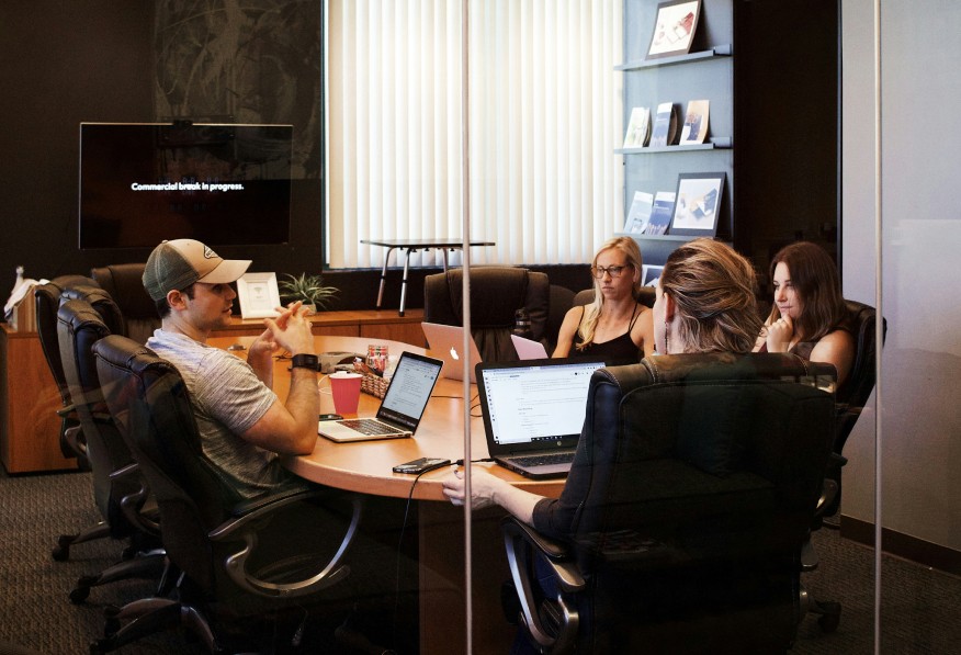 Team surrounding a table and having a meeting