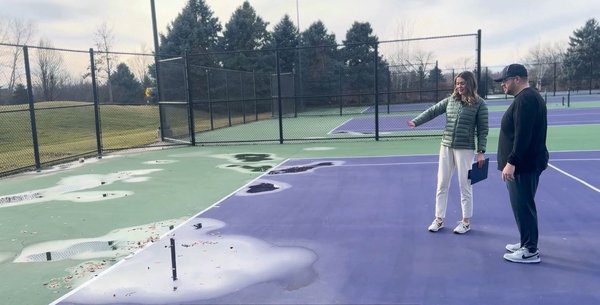 Tennis court reconstruction assessment with standing water and surface drainage issues.
