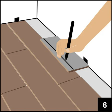 SPC地板DIY安裝教學：師傅示範用鉛筆在石塑地板標記裁切位置，確保家居地台鎖扣地板精準鋪砌。