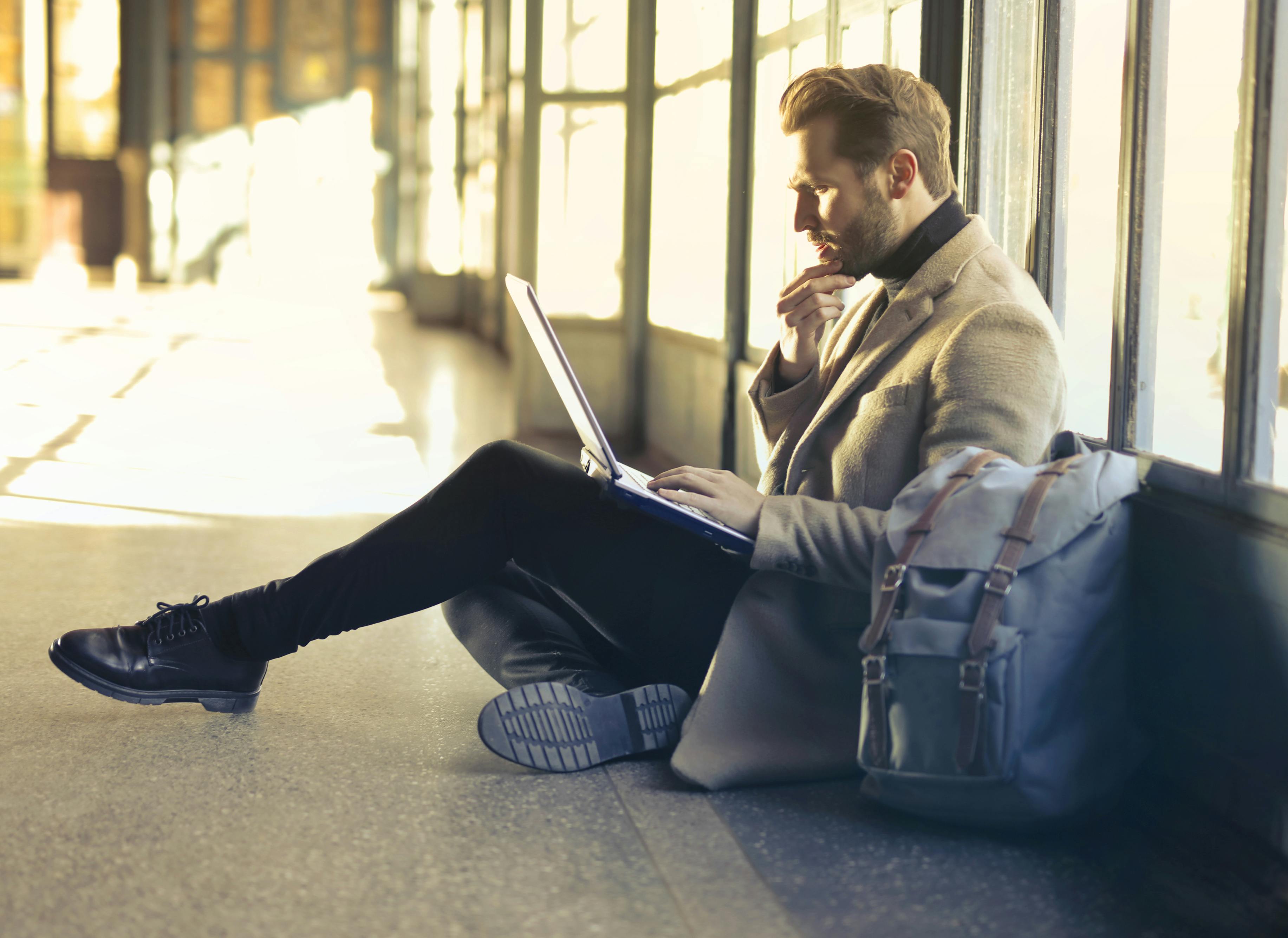 A founder working with his laptop at the airport'