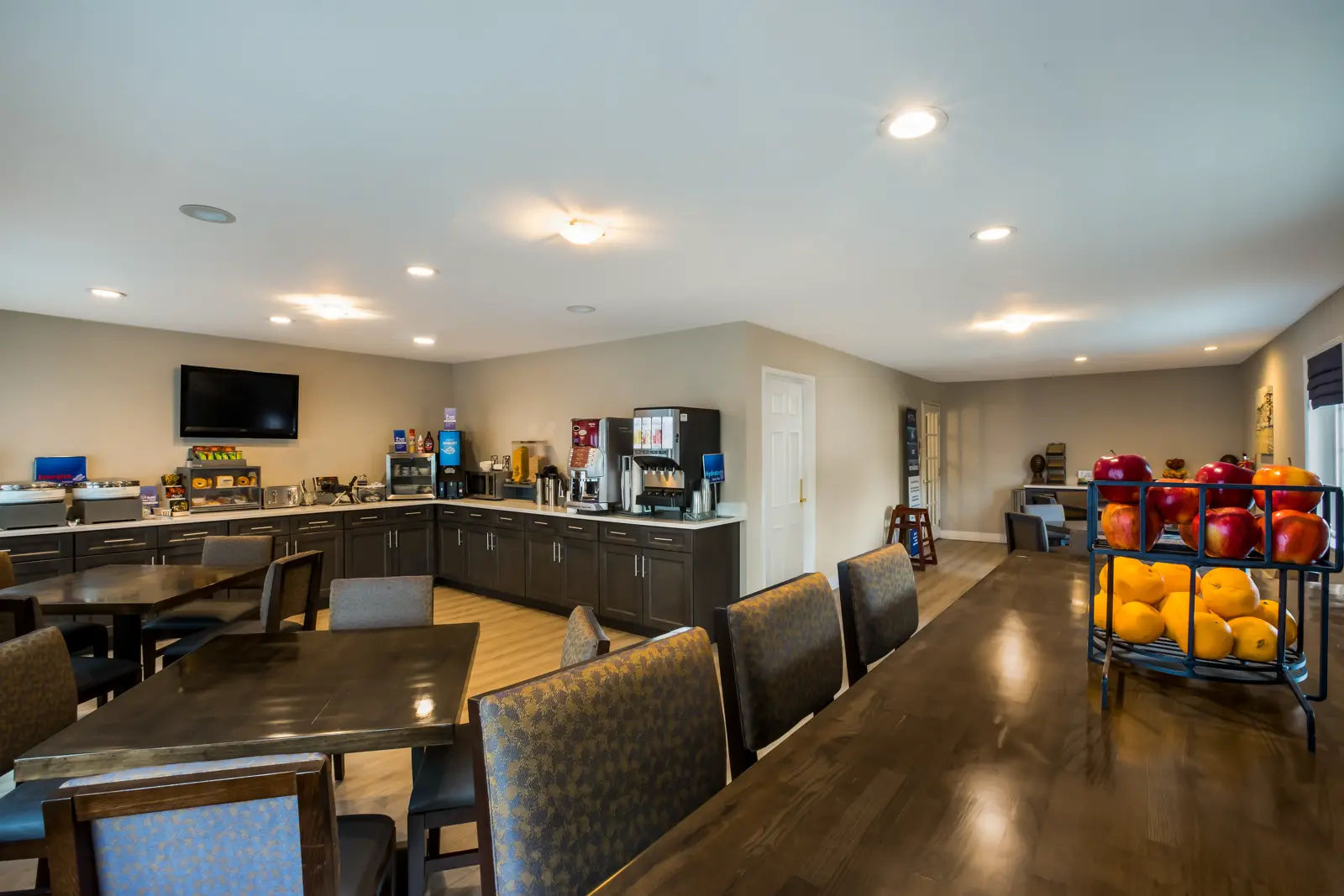 Dining area with a fruit stand and beverage station.