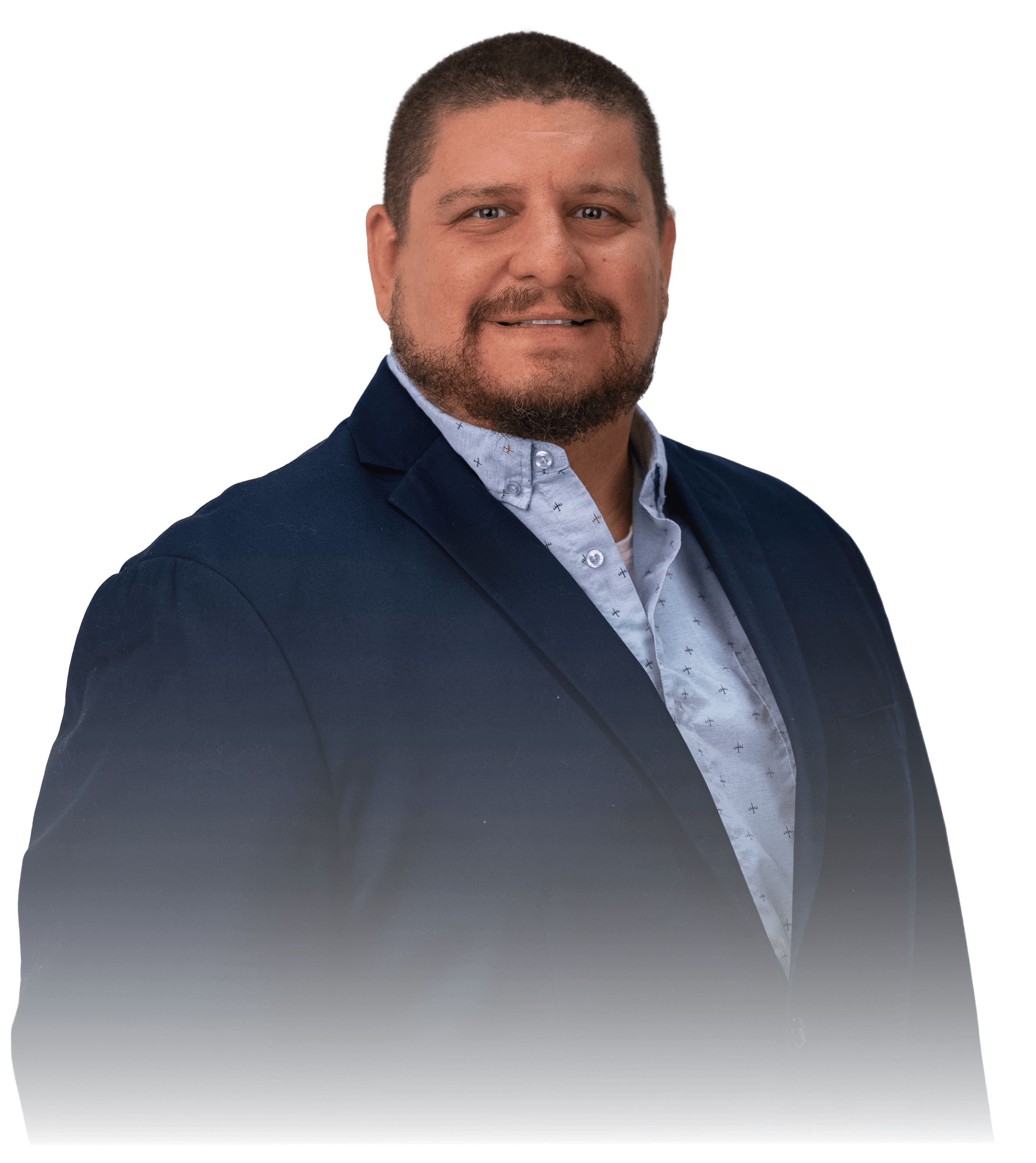 Two people in a workshop, one standing and smiling while the other leans over a car, working on it.