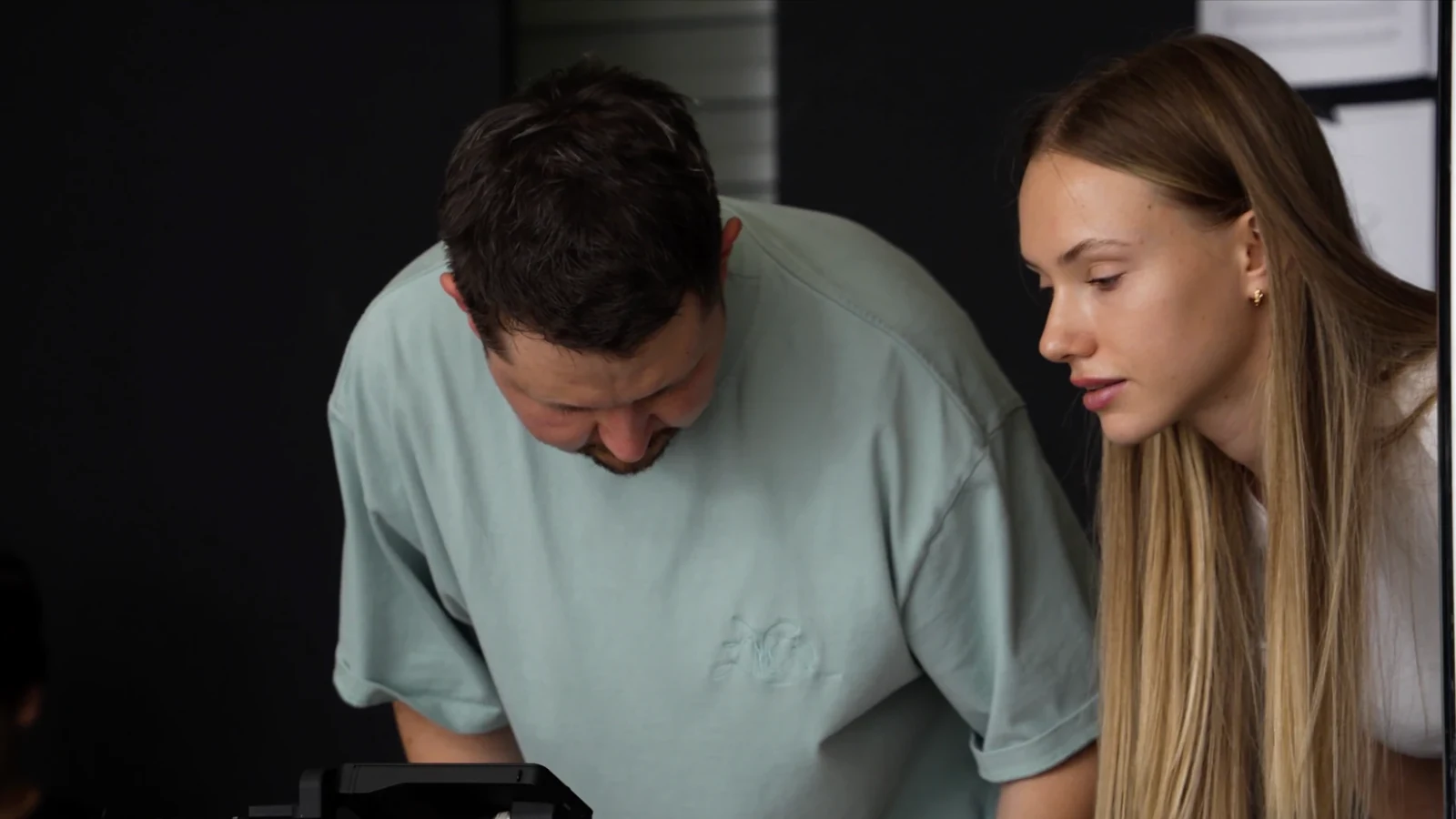 Producer and assistant checking a take on the monitor