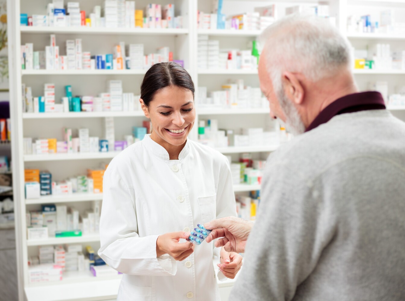older man talking to a pharmacist to discuss the best OTC weight loss pills that are actually safe