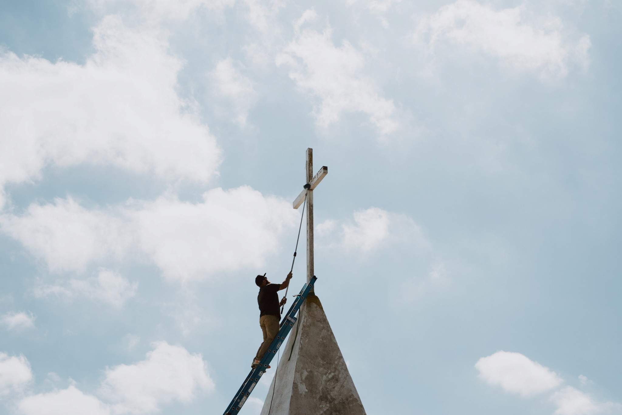 person sitting on grass and using phone