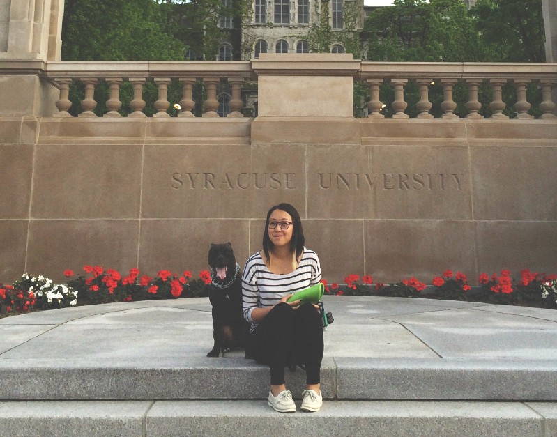 A women in front of Syracuse University