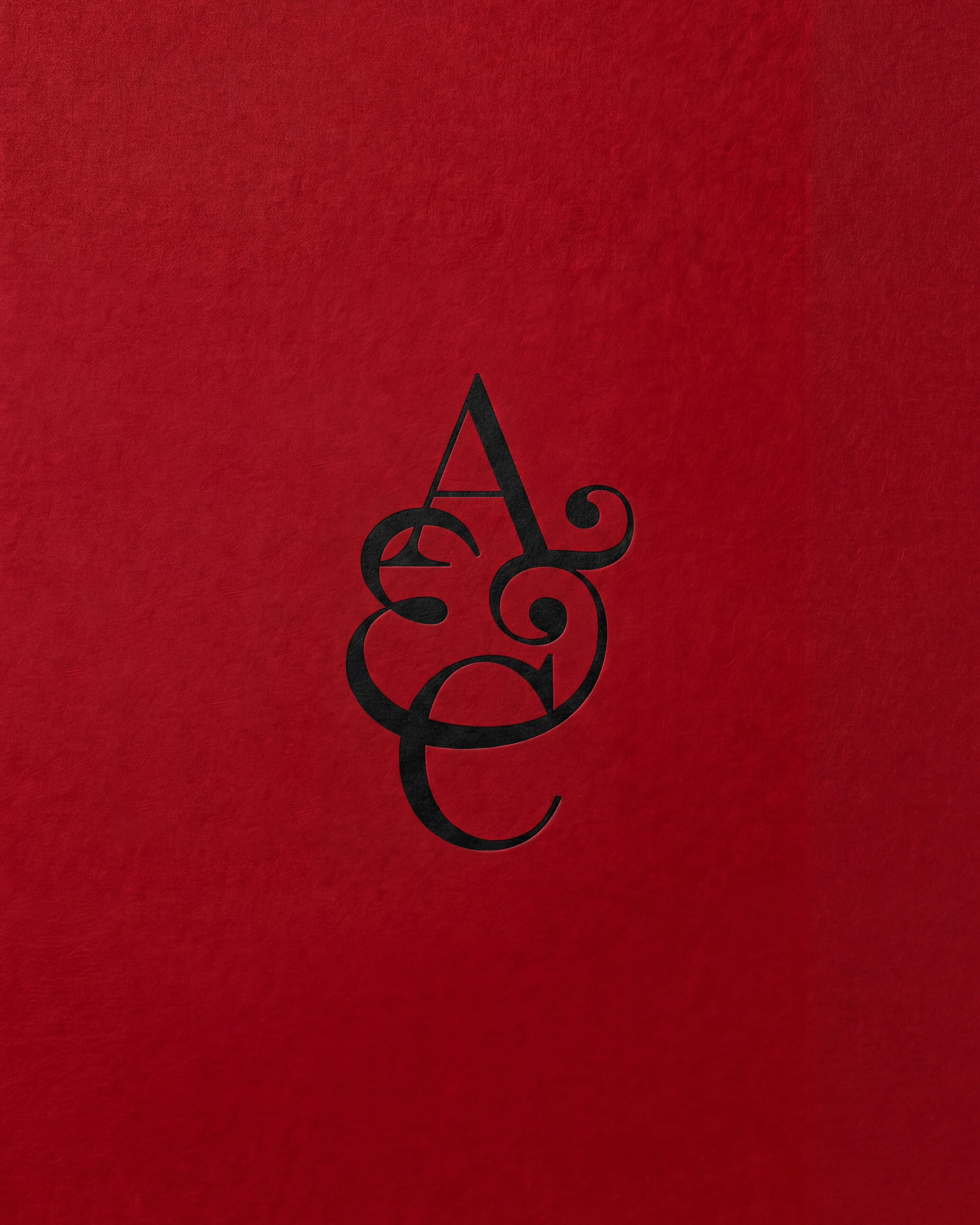 Arcos & Conde monogram in black on red paper, brand identity design by Sebastian Saavedra