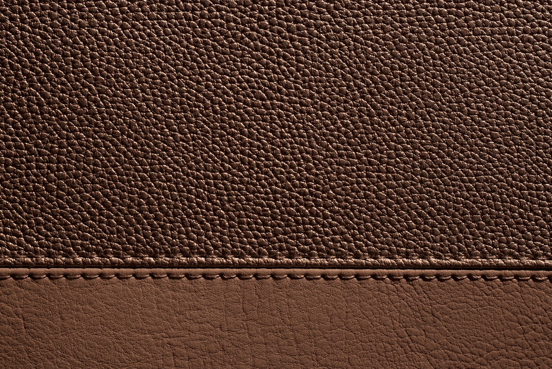 close-up top-grain leather texture and reinforced handbag stitching