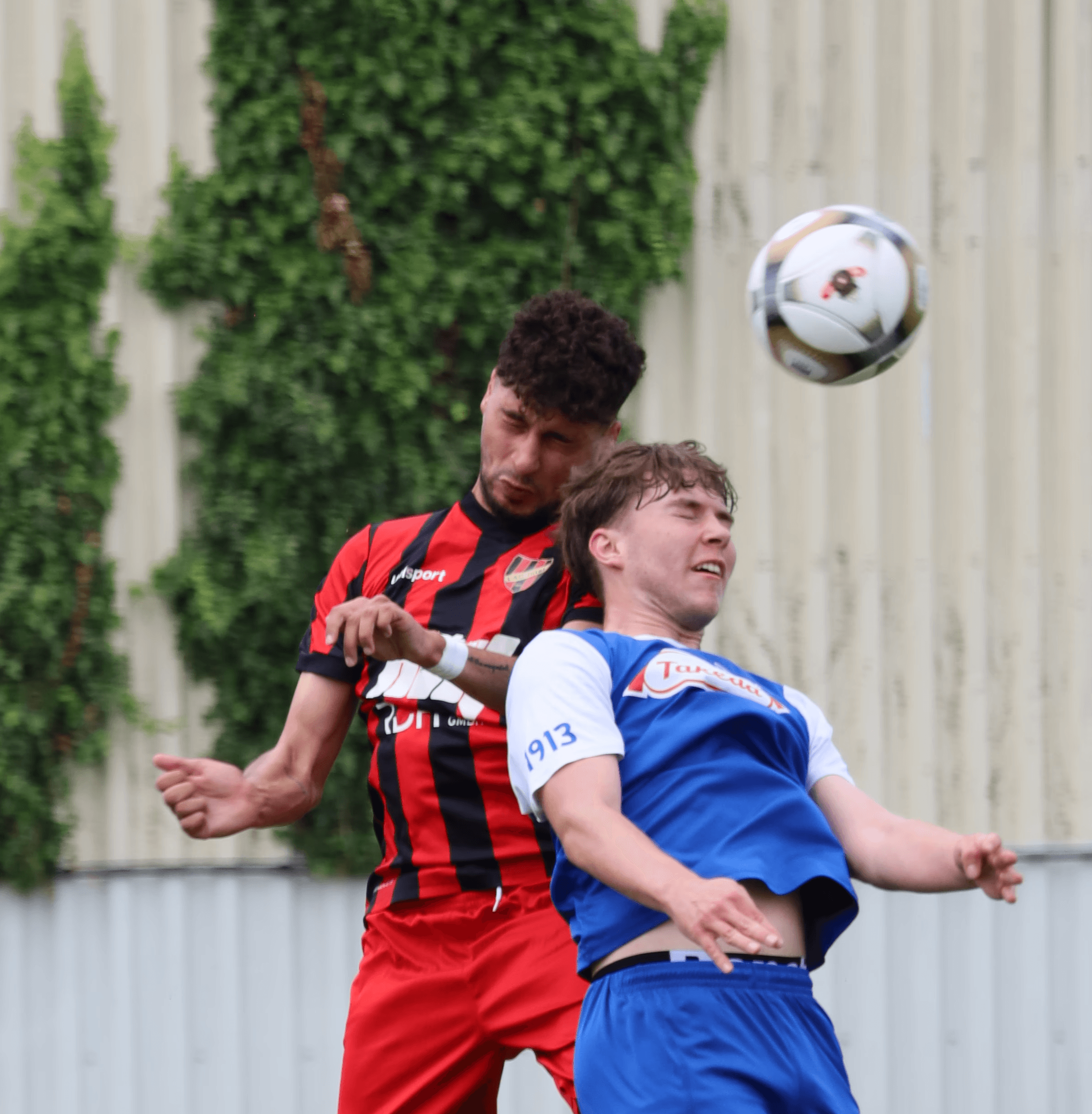 Two players go into heading duel for the ball