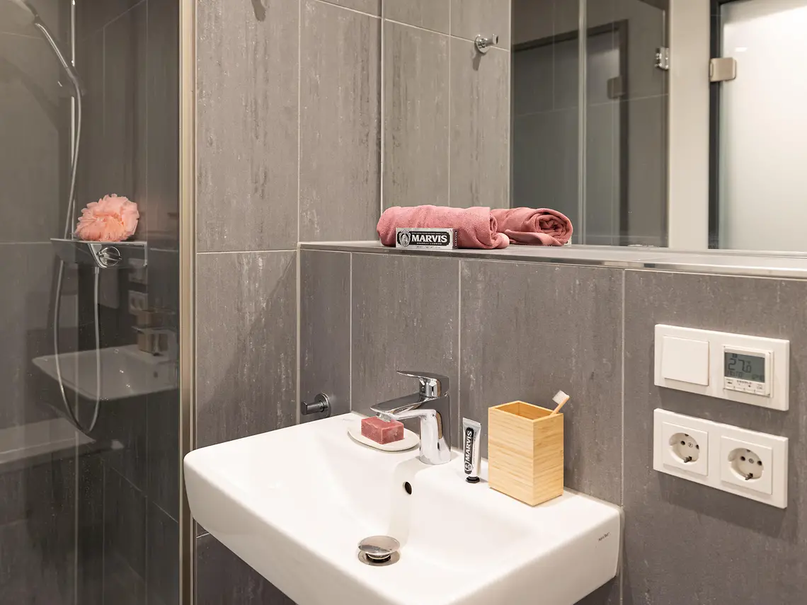 Private bathroom in student accommodation in Darmstadt with shower, sink and mirror