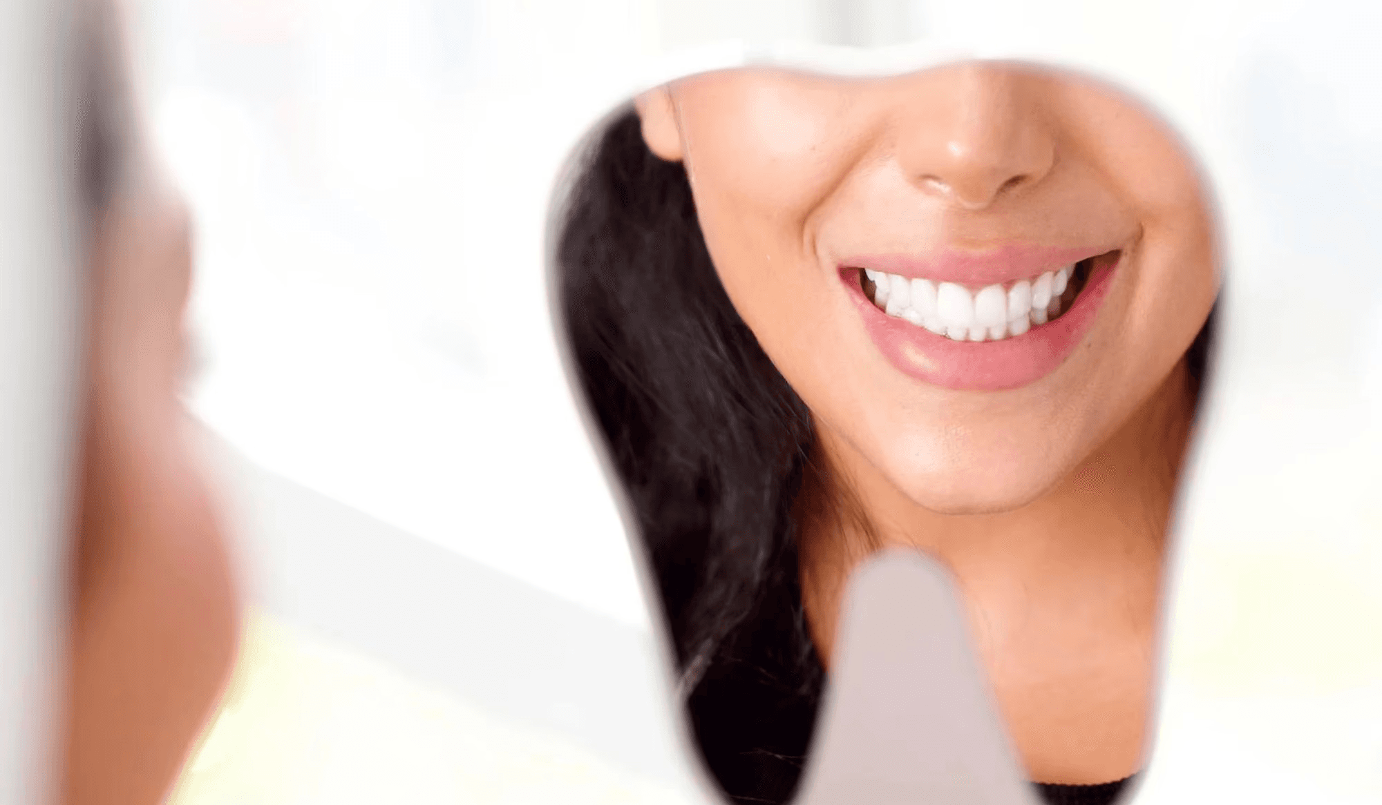 A woman showcasing her beautiful smile with dental crowns by Invisalign Center