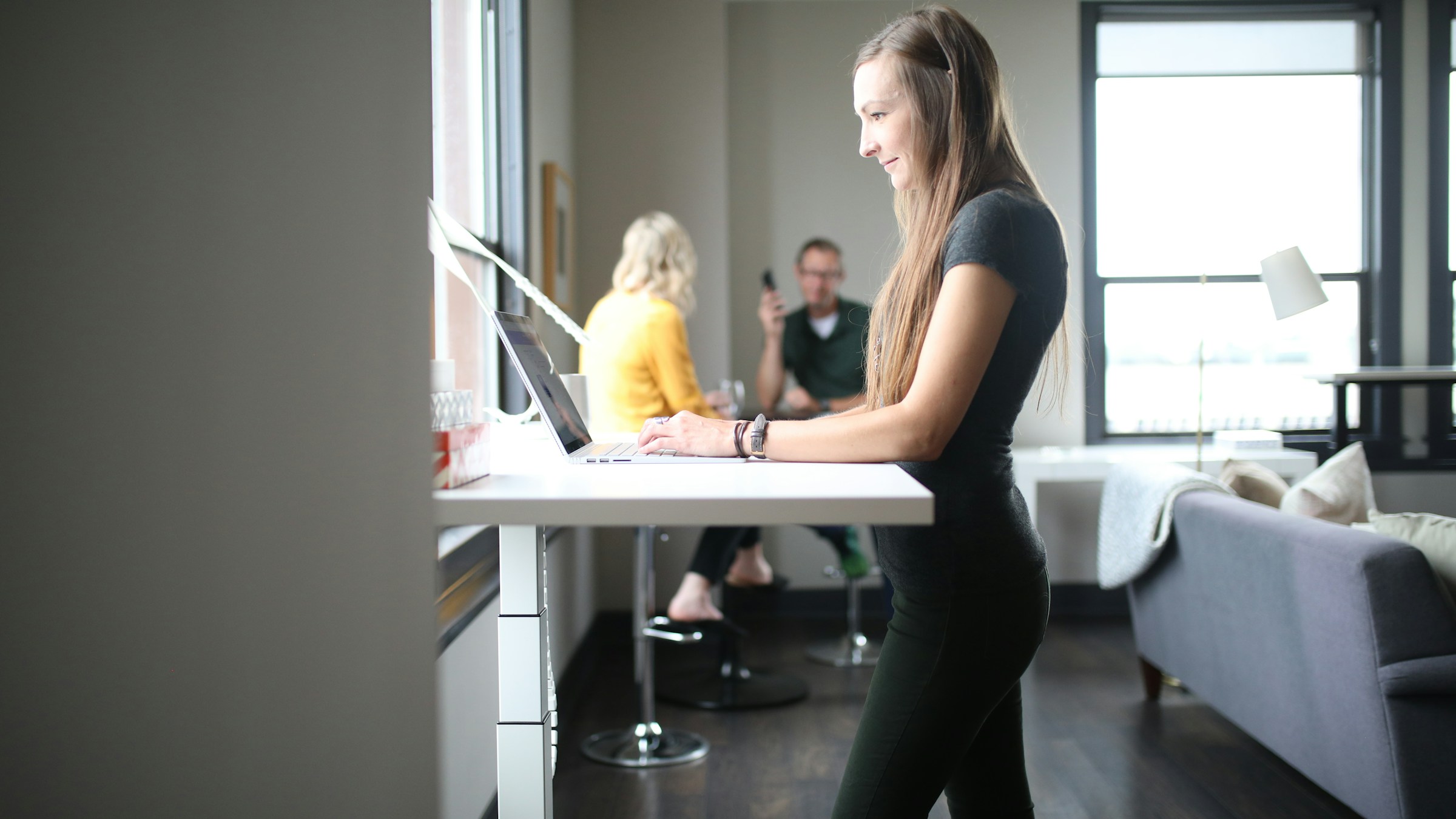 woman working on standing desk - What Good Posture Looks Like