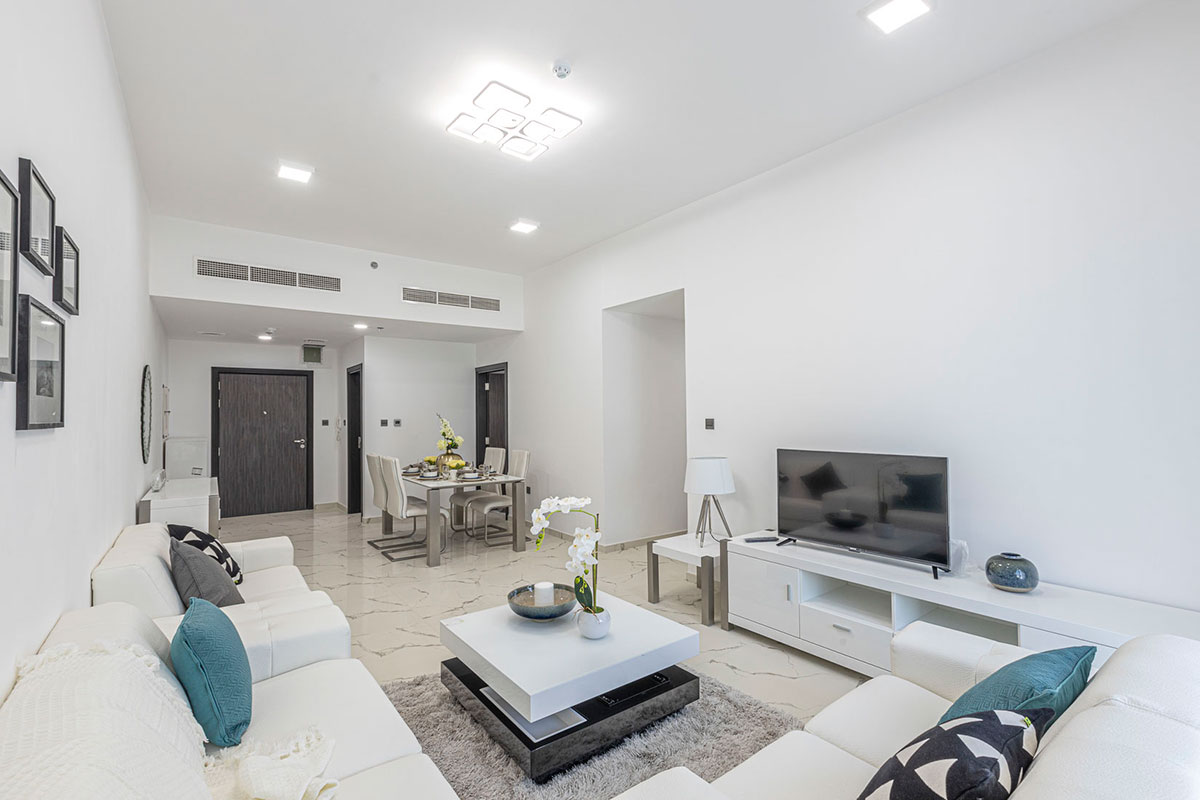 Spacious, bright living room and dining area in a luxury Geepas Tower residence for sale.