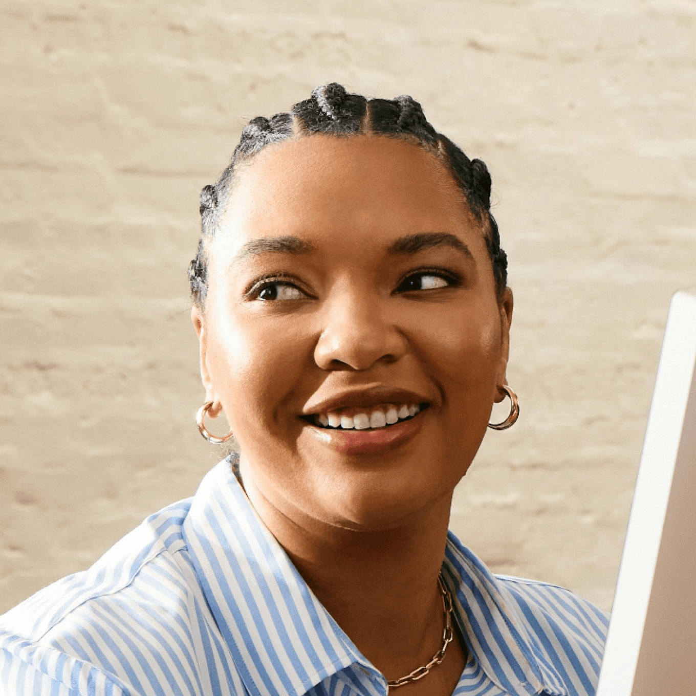 A woman smiling while working at a computer