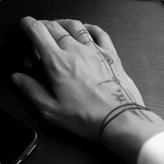 hand with fine-line tattoo