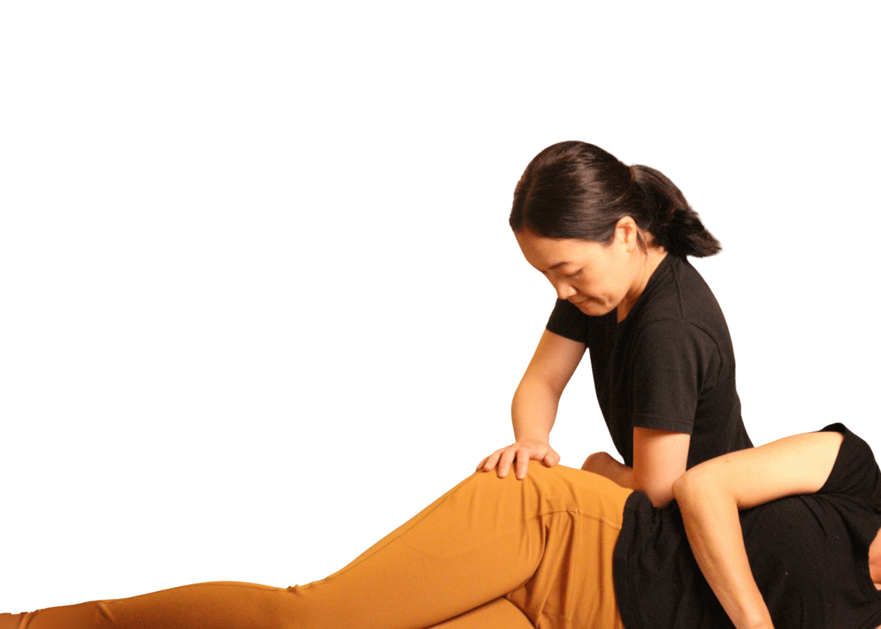 Massage therapist treating a patient's hip on a massage table