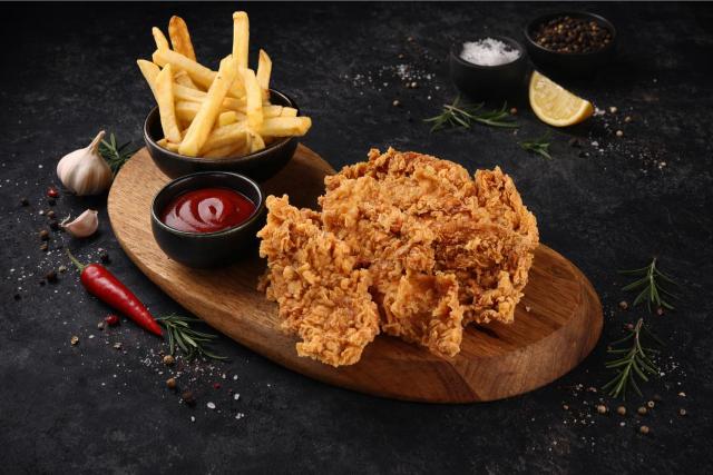 a white plate topped with fried food on top of a wooden table