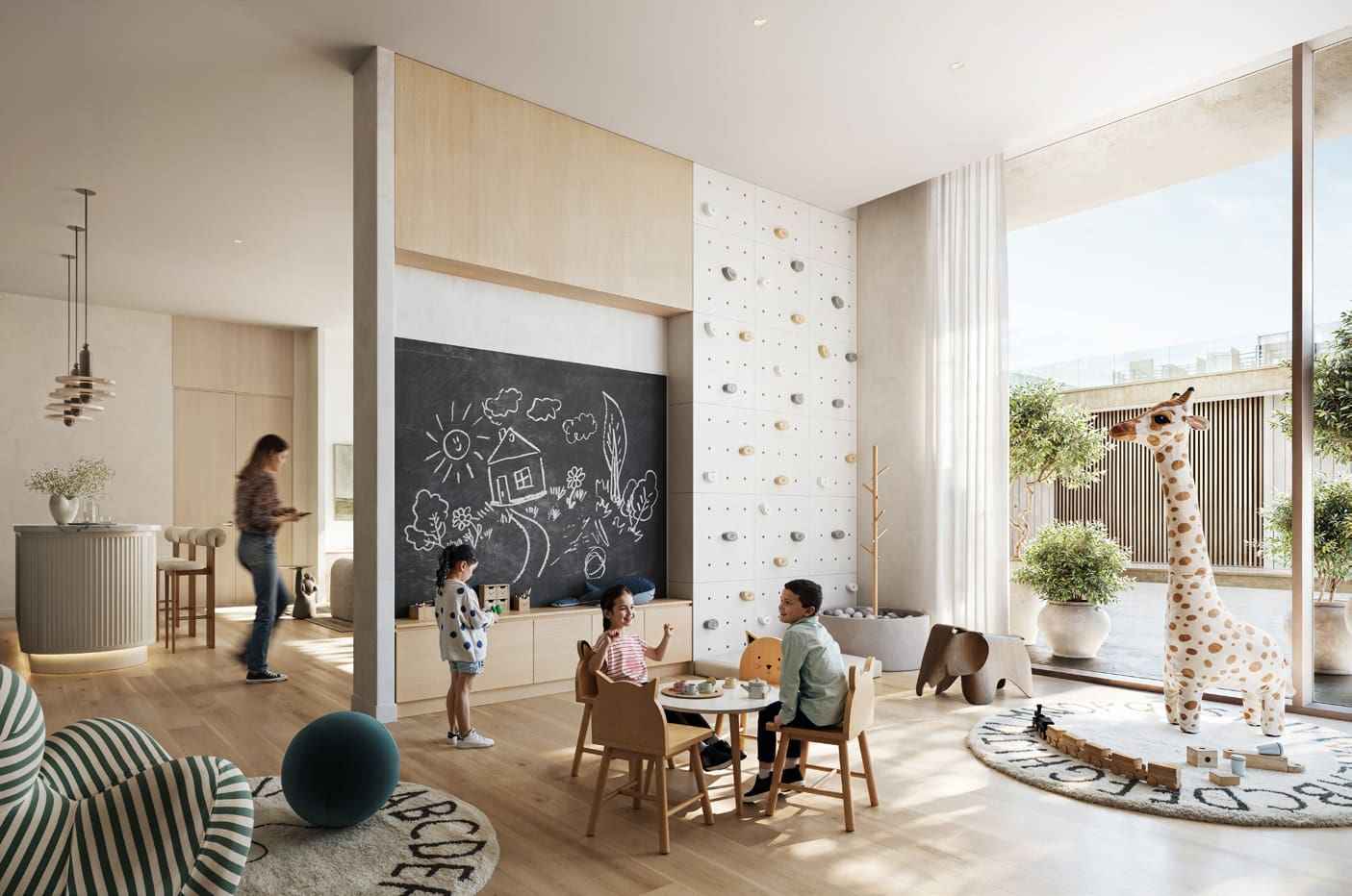 A colorful children's playroom featuring a chalkboard and a tall giraffe toy at Address Residences.