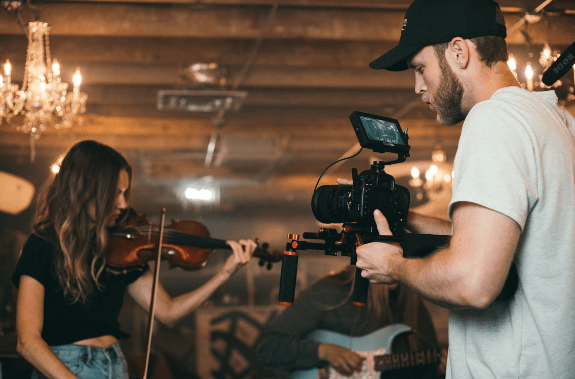 a guy filming a woman