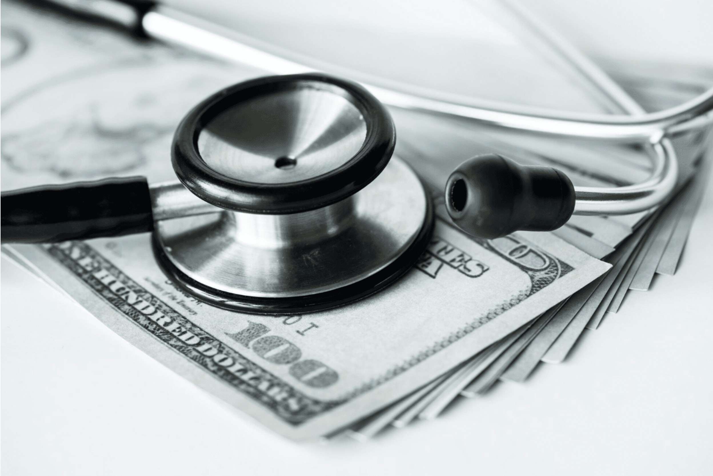 Closeup of cash and a stethoscope healthcare and expenses concept. Courtesy of Pexels