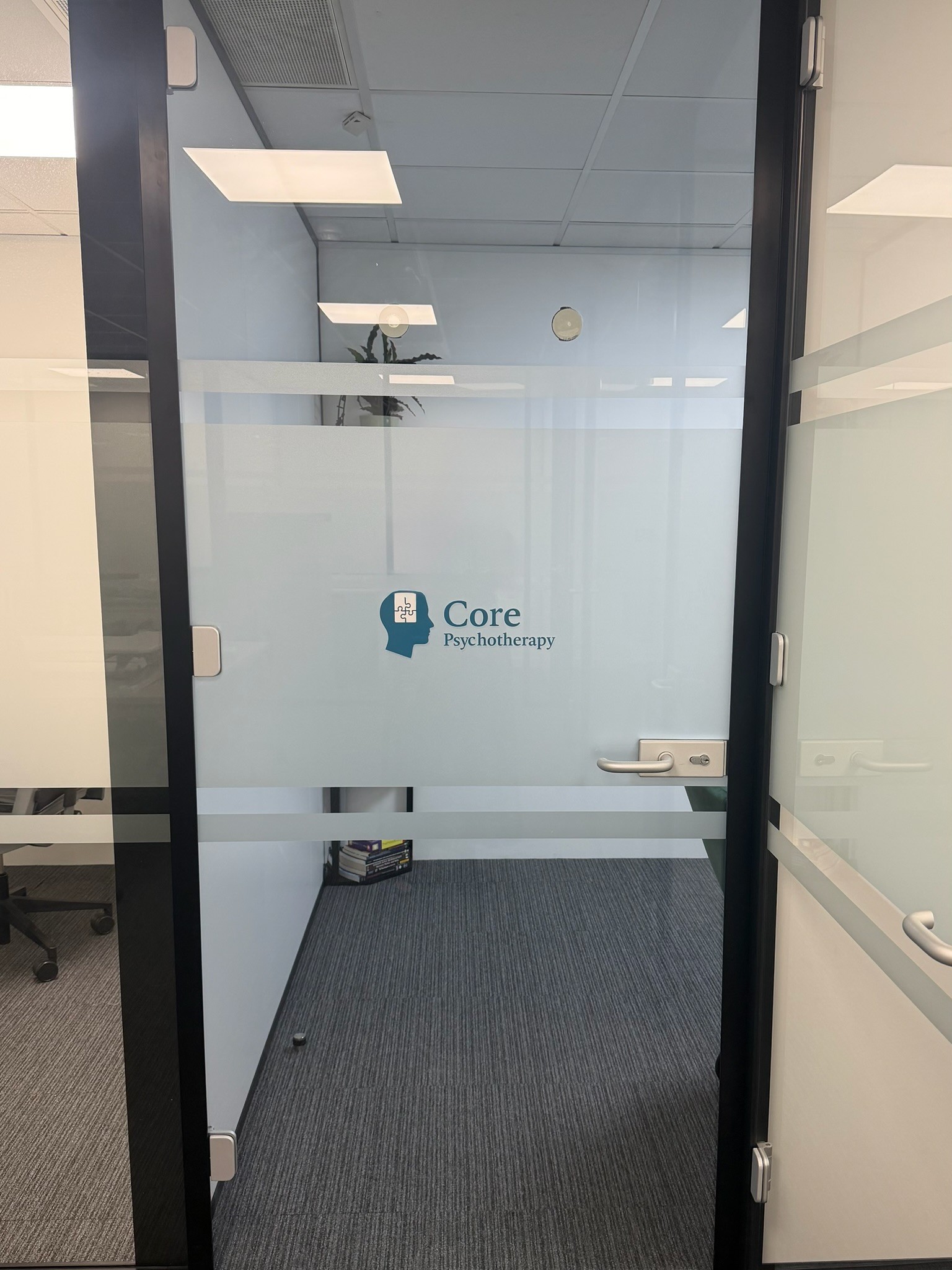 Glass entrance door with the Core Psychotherapy logo at the Croydon practice
