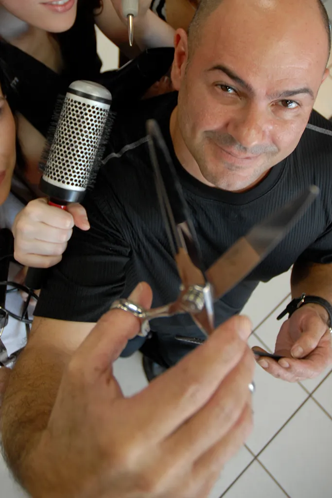 Gino styling a client’s hair