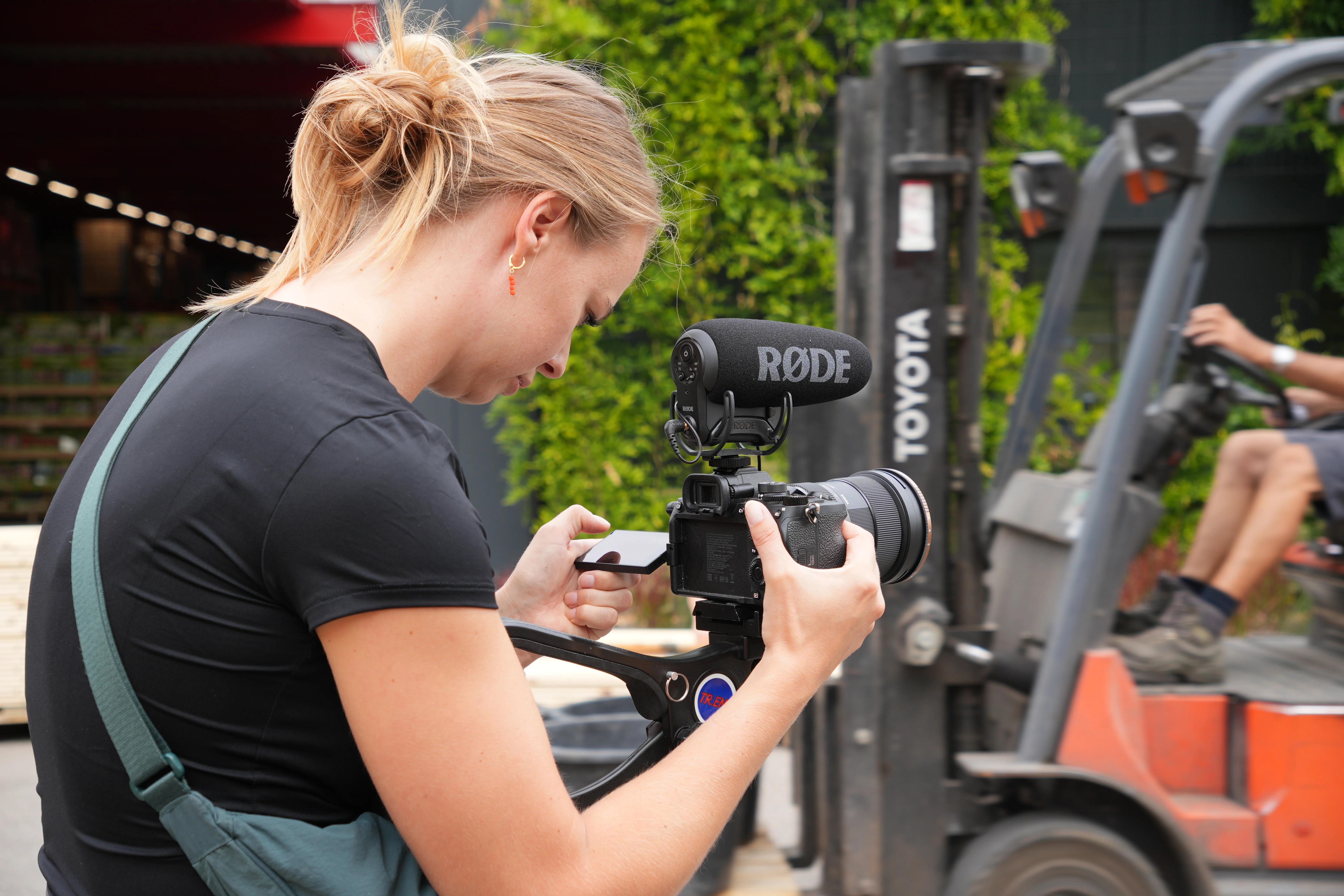 A red hot air balloon glows at sunset over mountains.