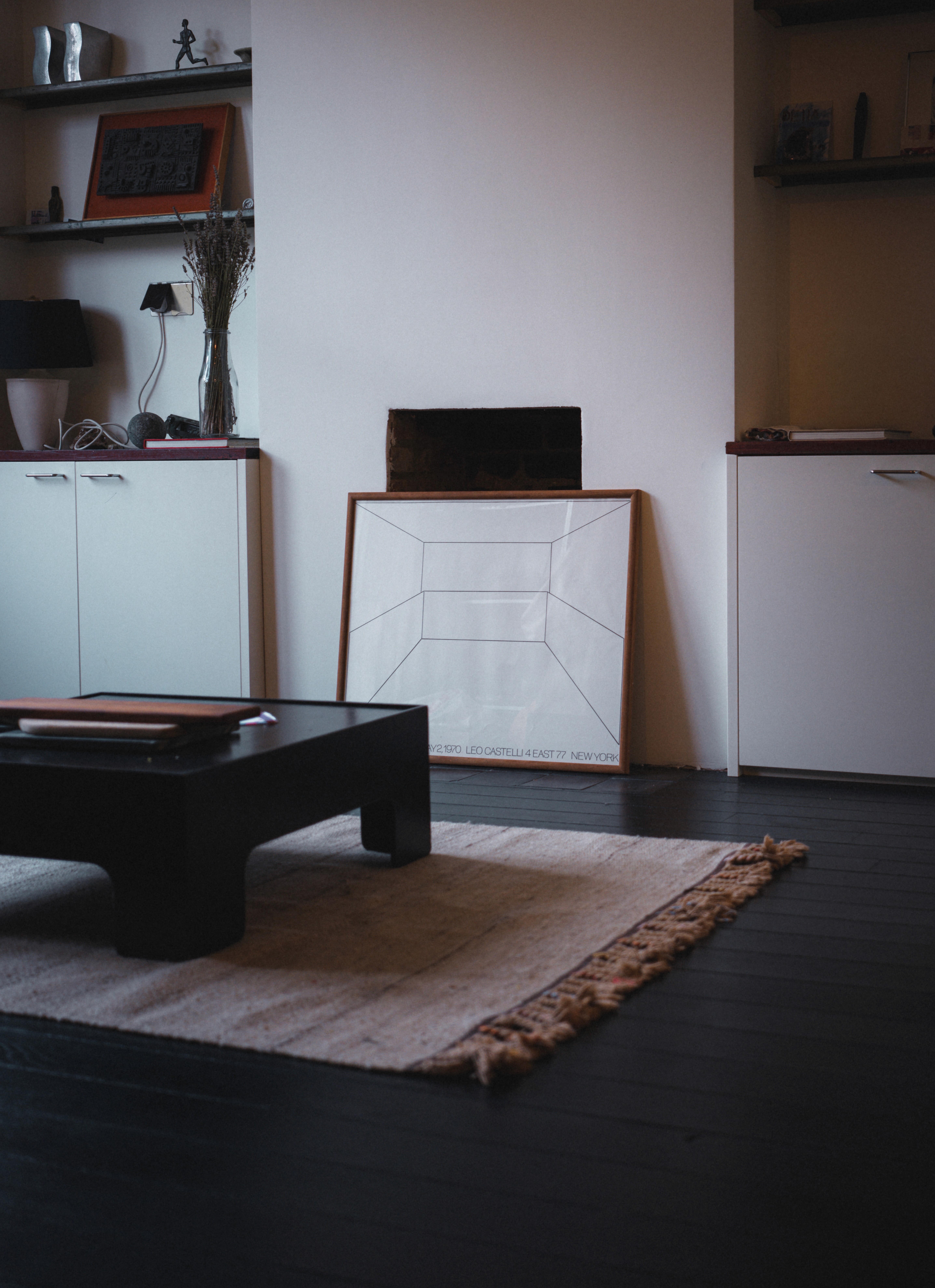 Contemporary living room with dark flooring and layered neutral furnishings
