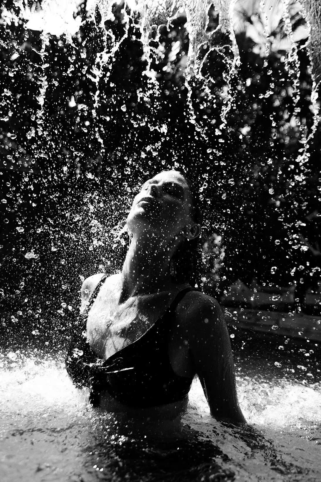 Woman enjoying a relaxing moment under the rain at Be Tulum, Tulum Mexico.