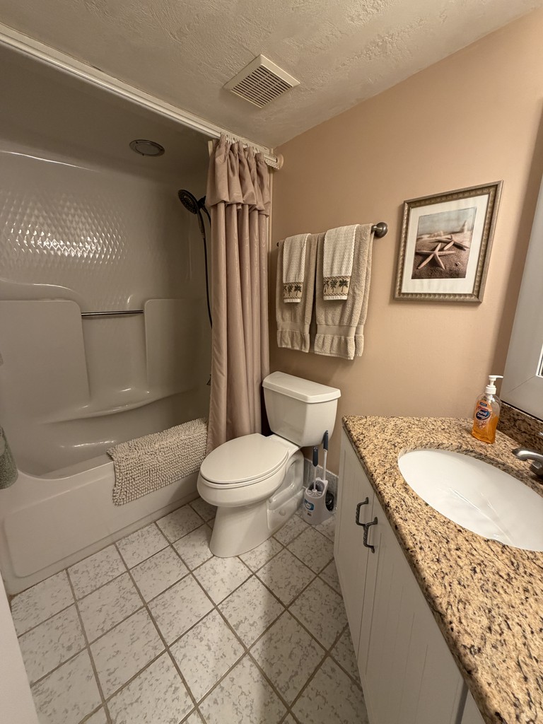 Bathroom with a tub shower and granite vanity, Unit 203 at Oceans Atrium, a vacation rental in Daytona Beach Shores