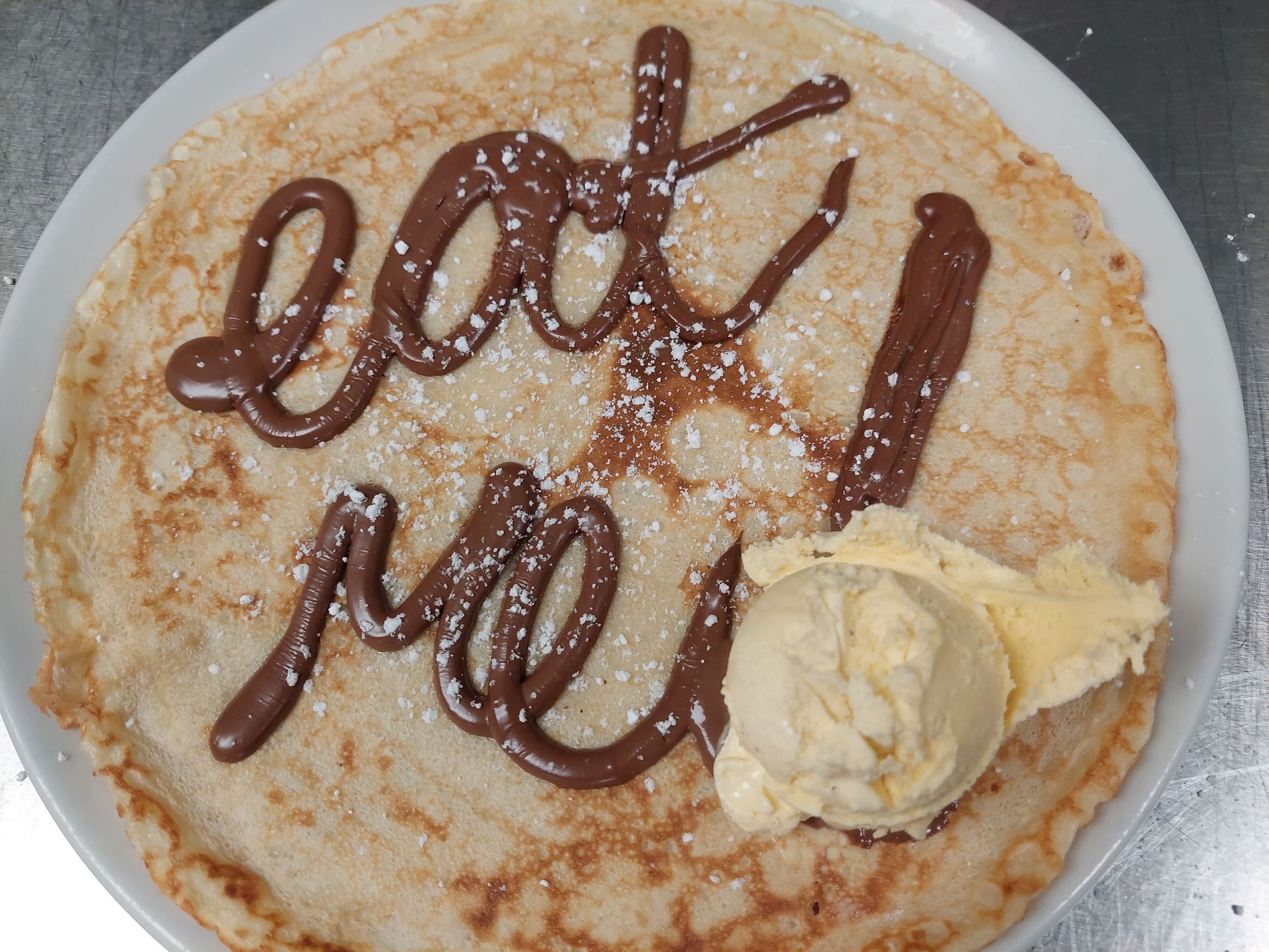 Pancake with nutella that spells 'eat me!'