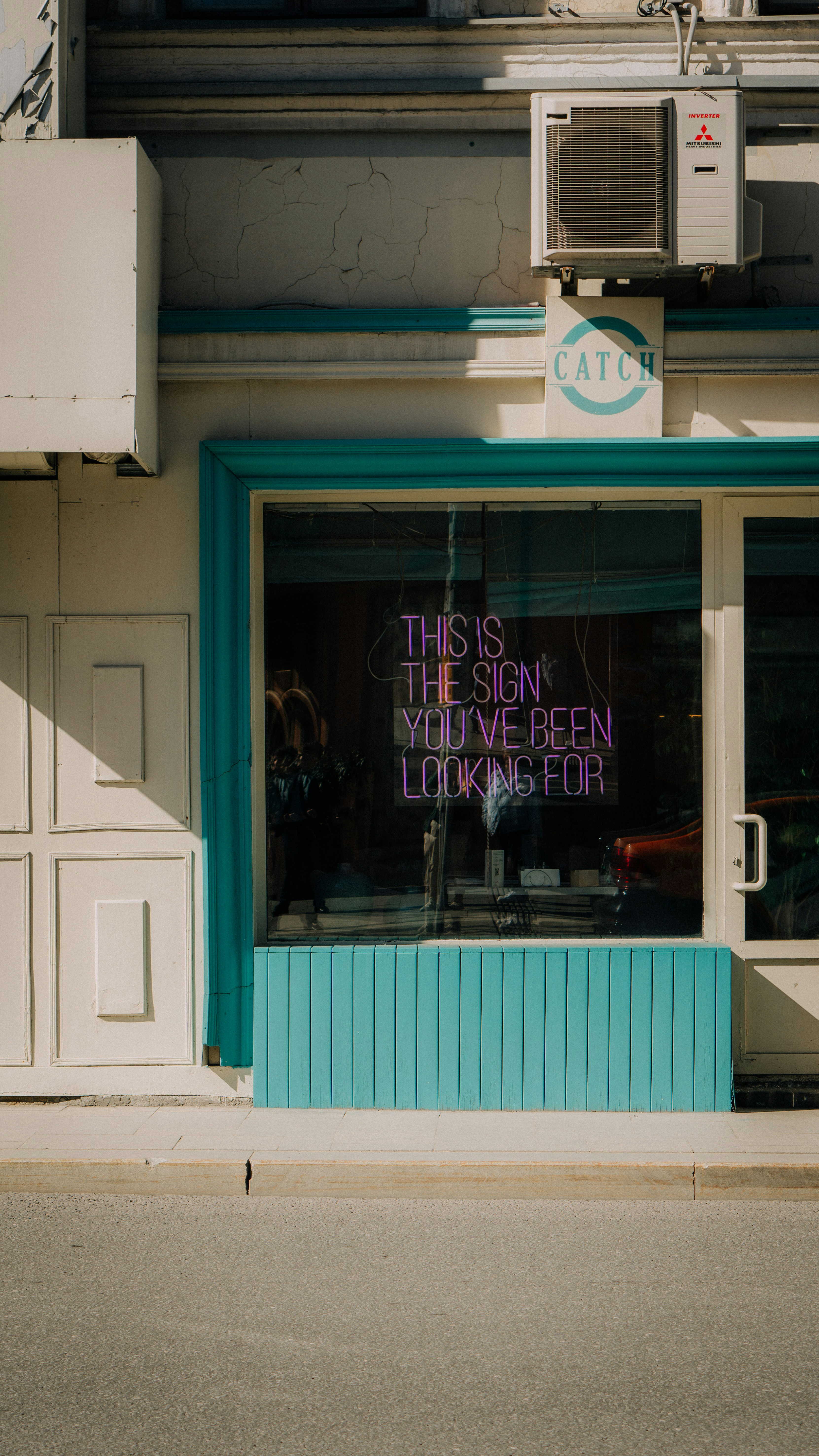 a store front with a neon sign in the window