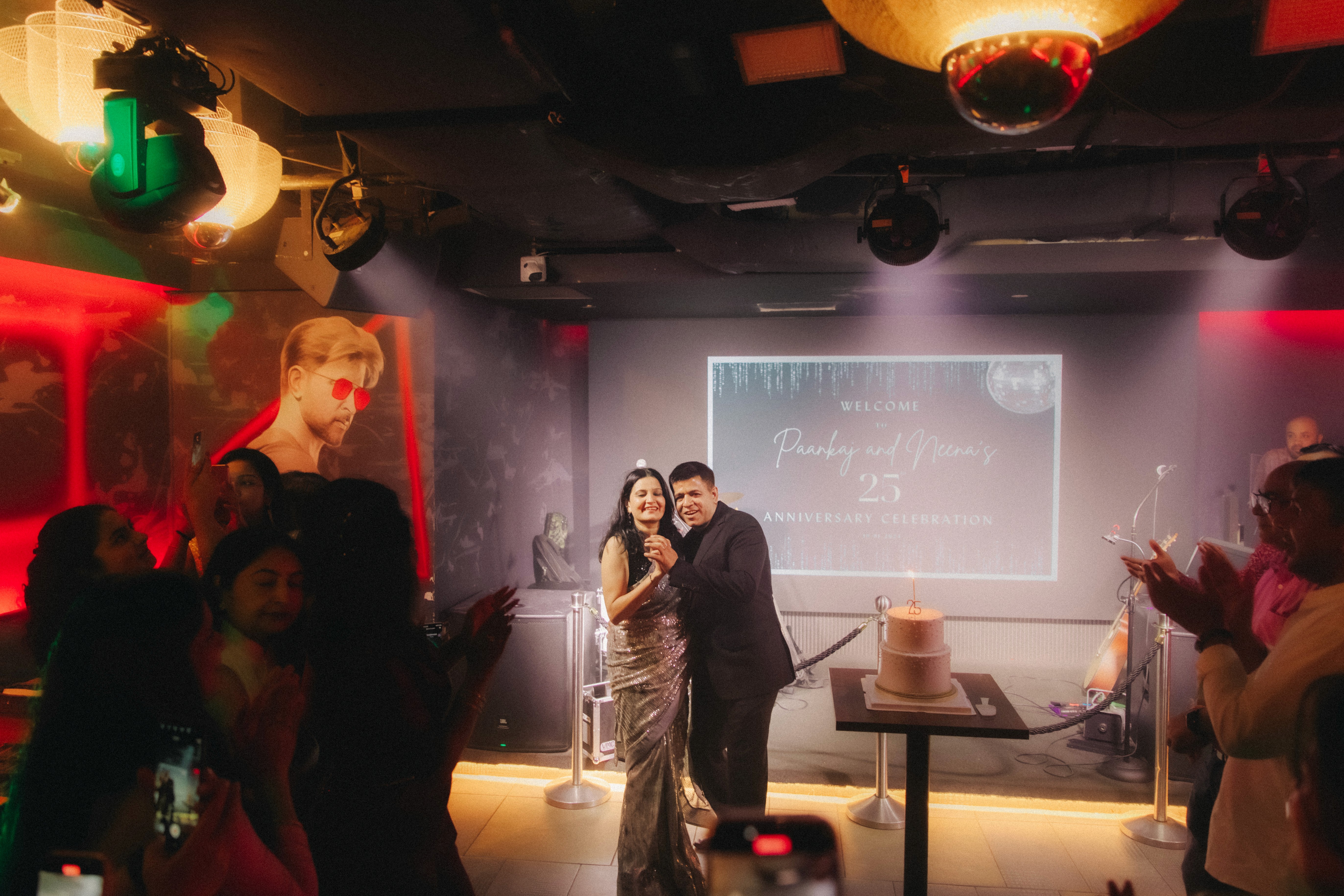 Couple enjoying their first dance as guests watch on, lively atmosphere at the event by JIREHTAKESPHOTOS in Singapore
