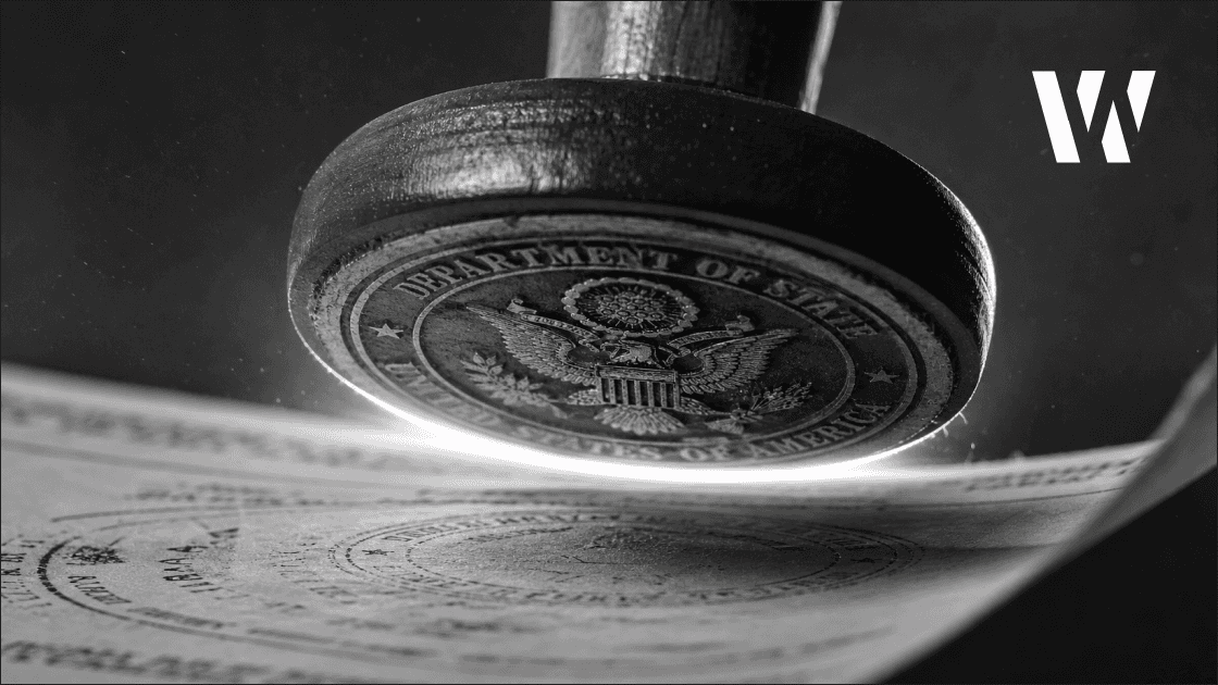 Extreme close-up of a government rubber stamp mid-press against official paper, rim-lit against a bright background.