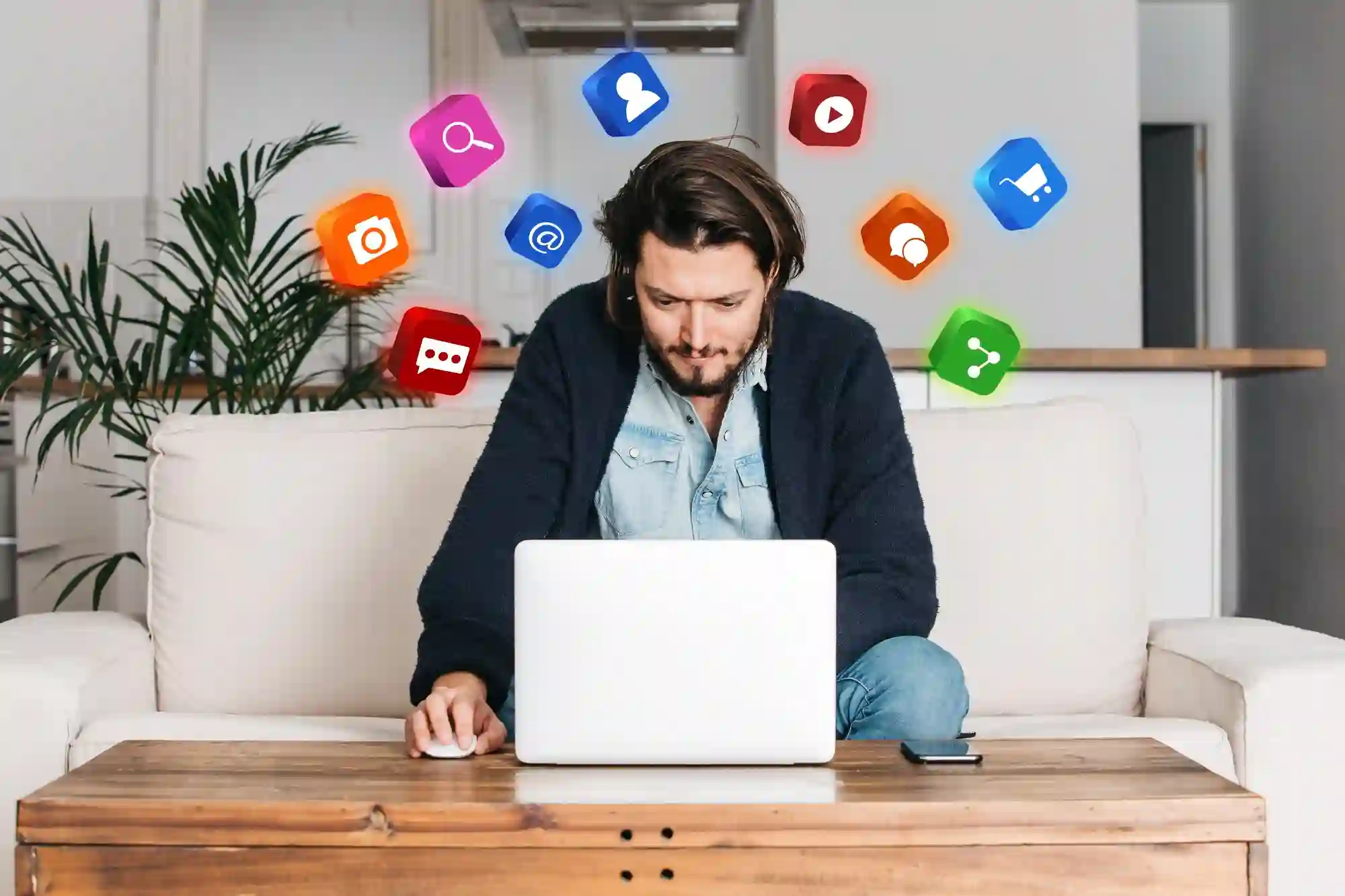 Man using a laptop with floating digital icons, representing multi-channel marketing and integrated software solutions for businesses.