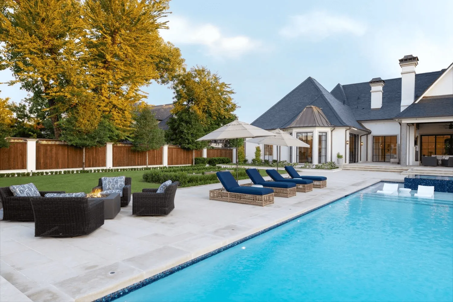 Custom negative edge spa with dark mosaic tile and resort pool for Preston Hollow Dallas estate by Blount Designs - different angle