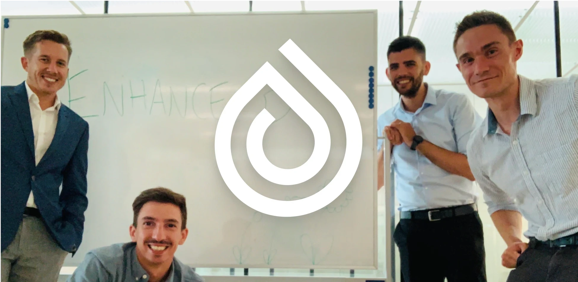 enhance-d team with their company logo, collaborating on digital health solutions in modern office setting.