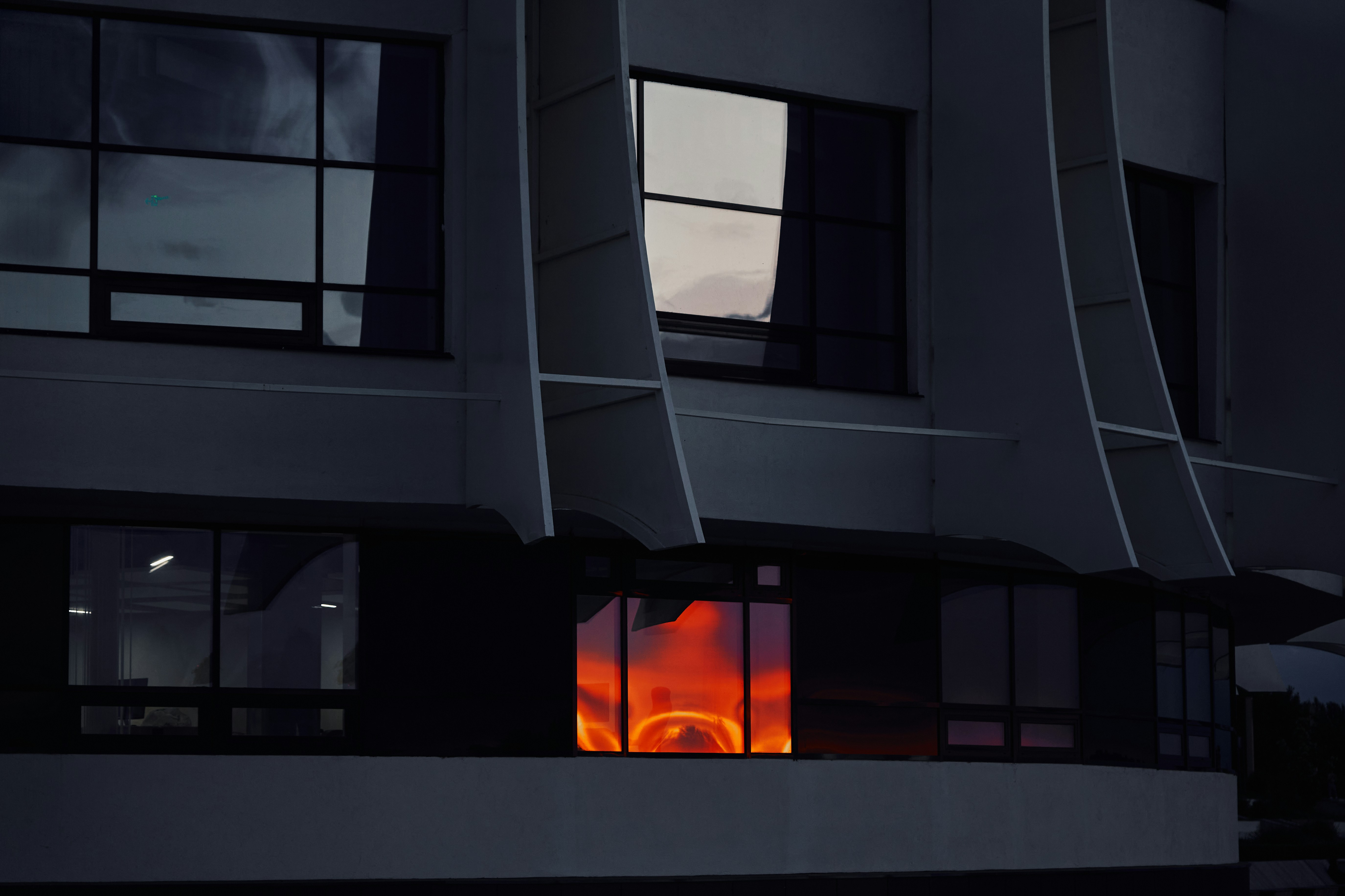 man in black crew neck t-shirt wearing black sunglasses holding black smartphone