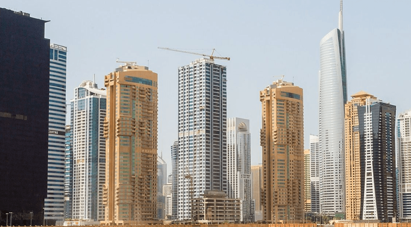 An overview of a residential district filled with greenery and structures, depicting a serene community atmosphere.