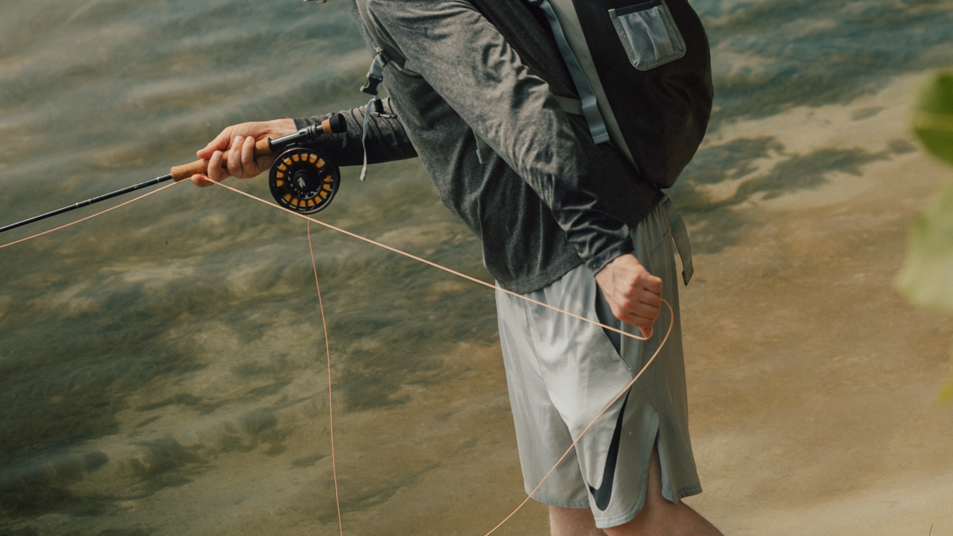Closeup of a saltwater angler stripsetting