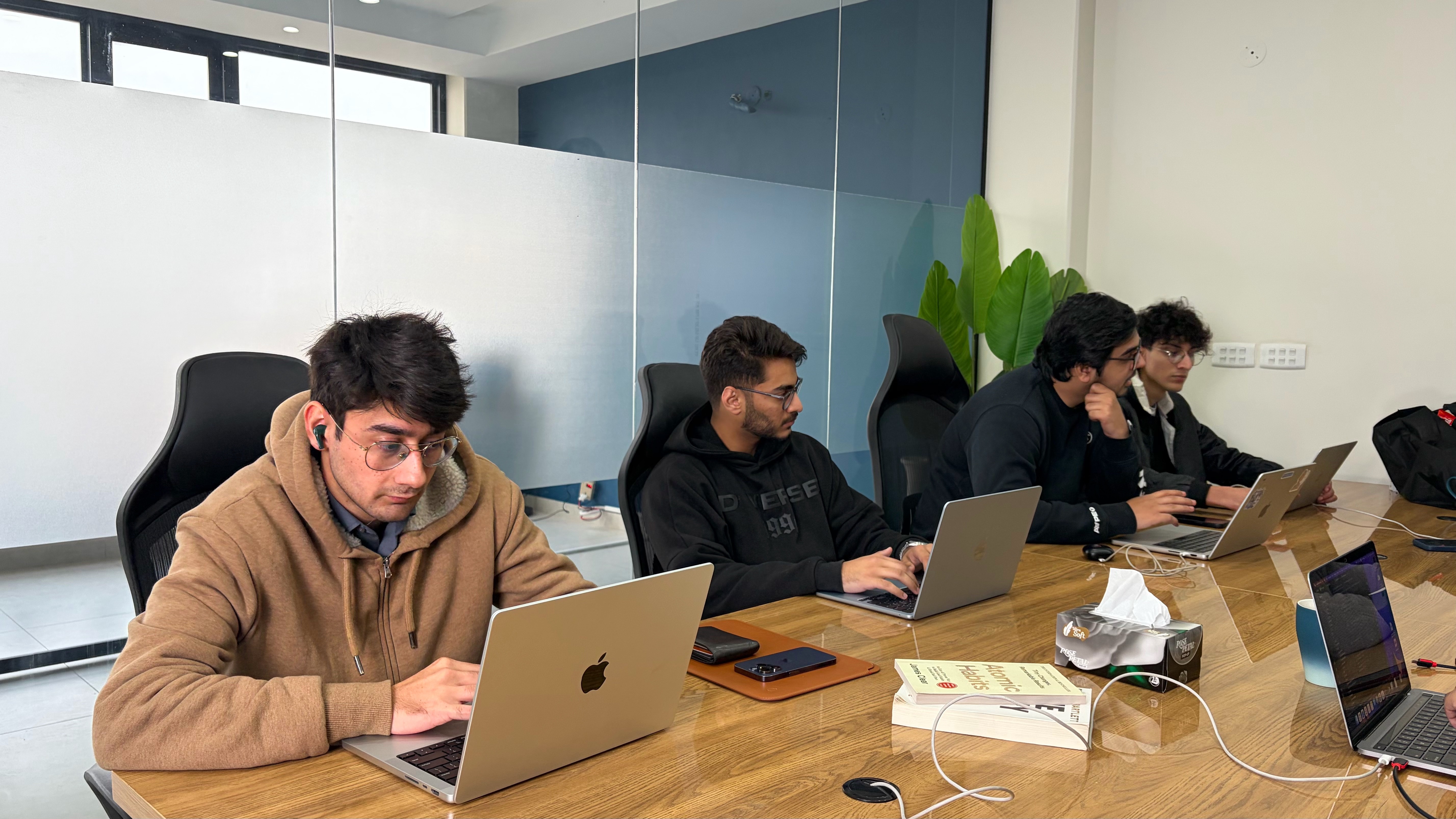 men sitting in front of their laptop computer
