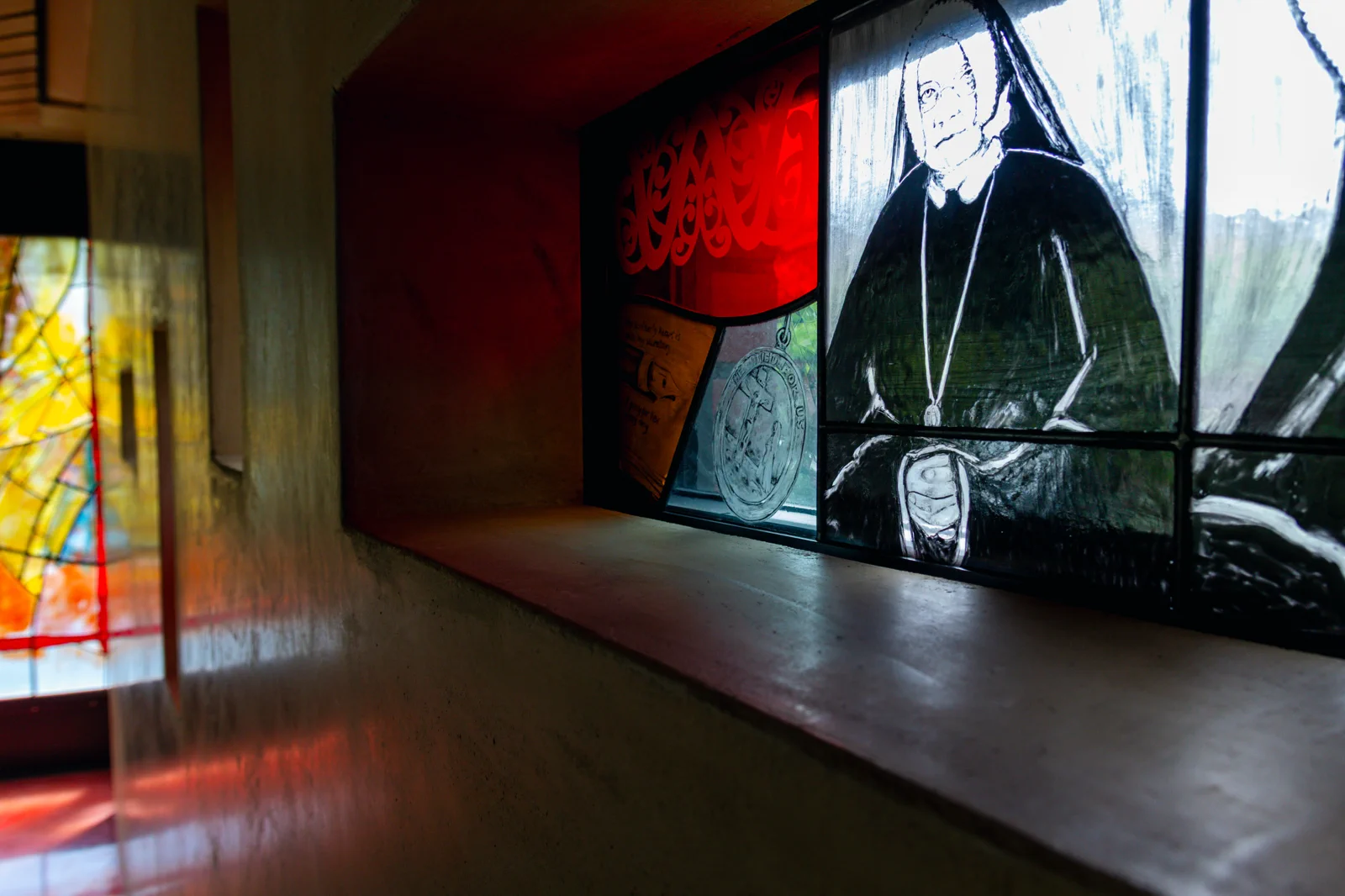Chapel display with stained glass and portrait