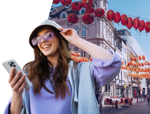 Woman smiling looking at her phone while using VisaBot mobile app