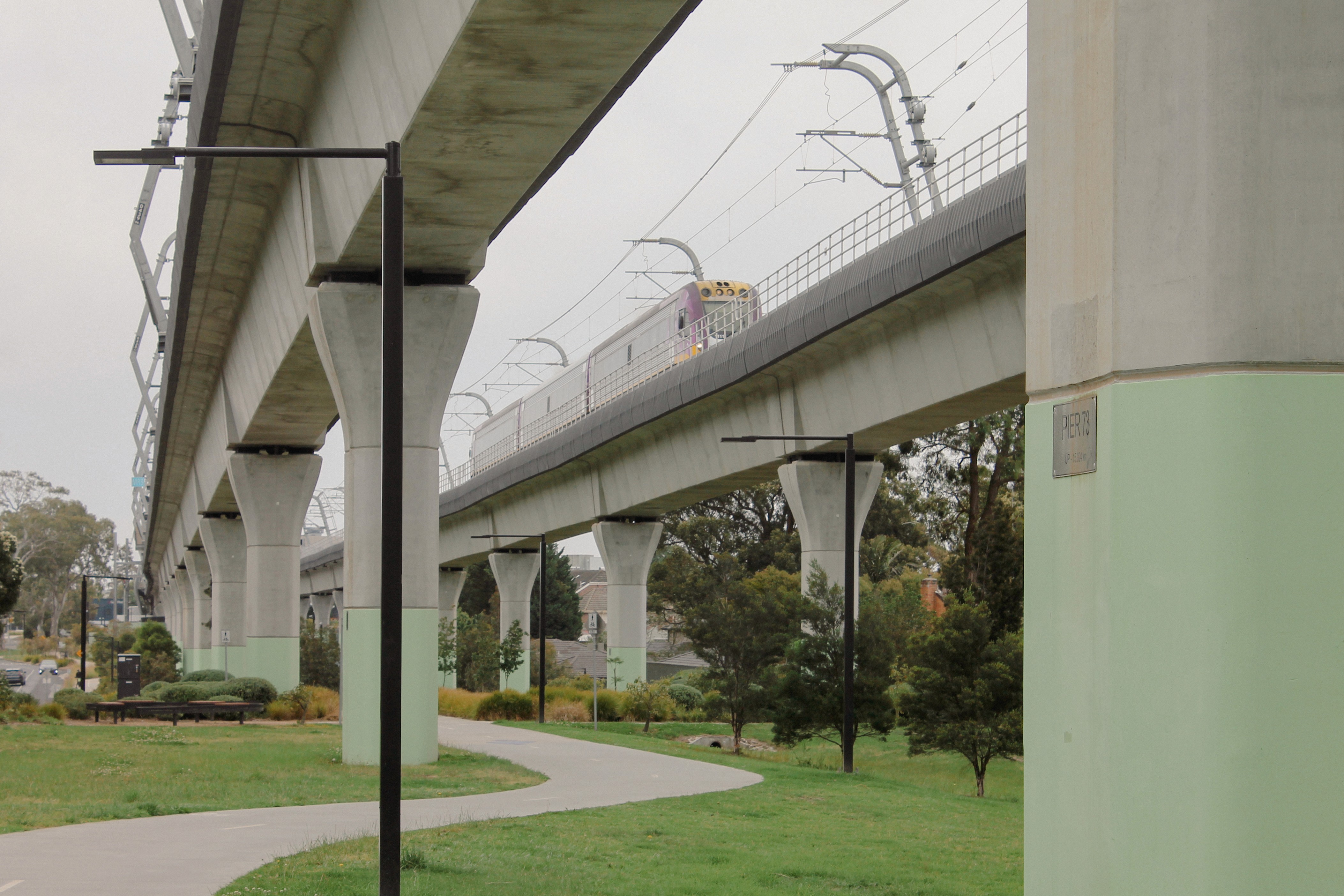 A bespoke light support bracket made of metal and painted yellow.