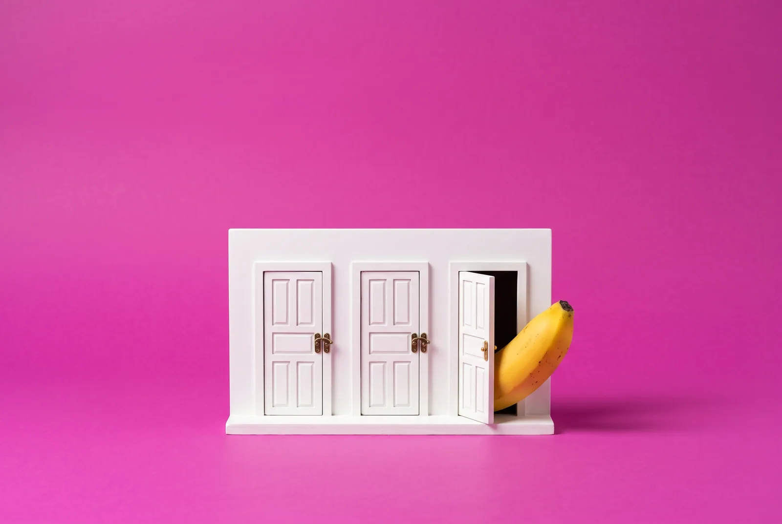 Three small doors, two latched and one ajar with a banana peeking out, closing other search engines when you lock SafeSearch