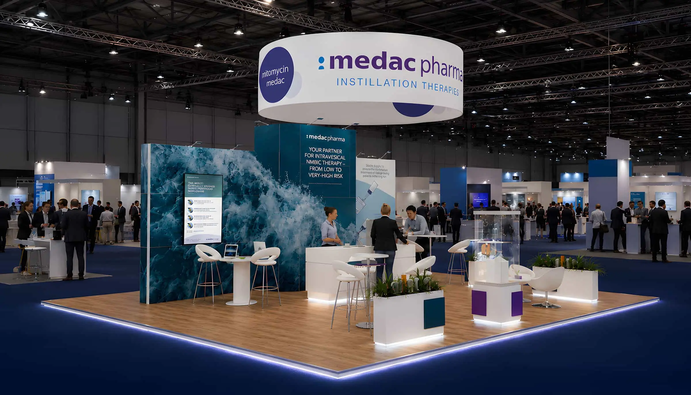 Island exhibition stand artwork with overhead circular hanging banner sign for medac Pharma BCG and Mitomycin therapies by Thomas Harvey