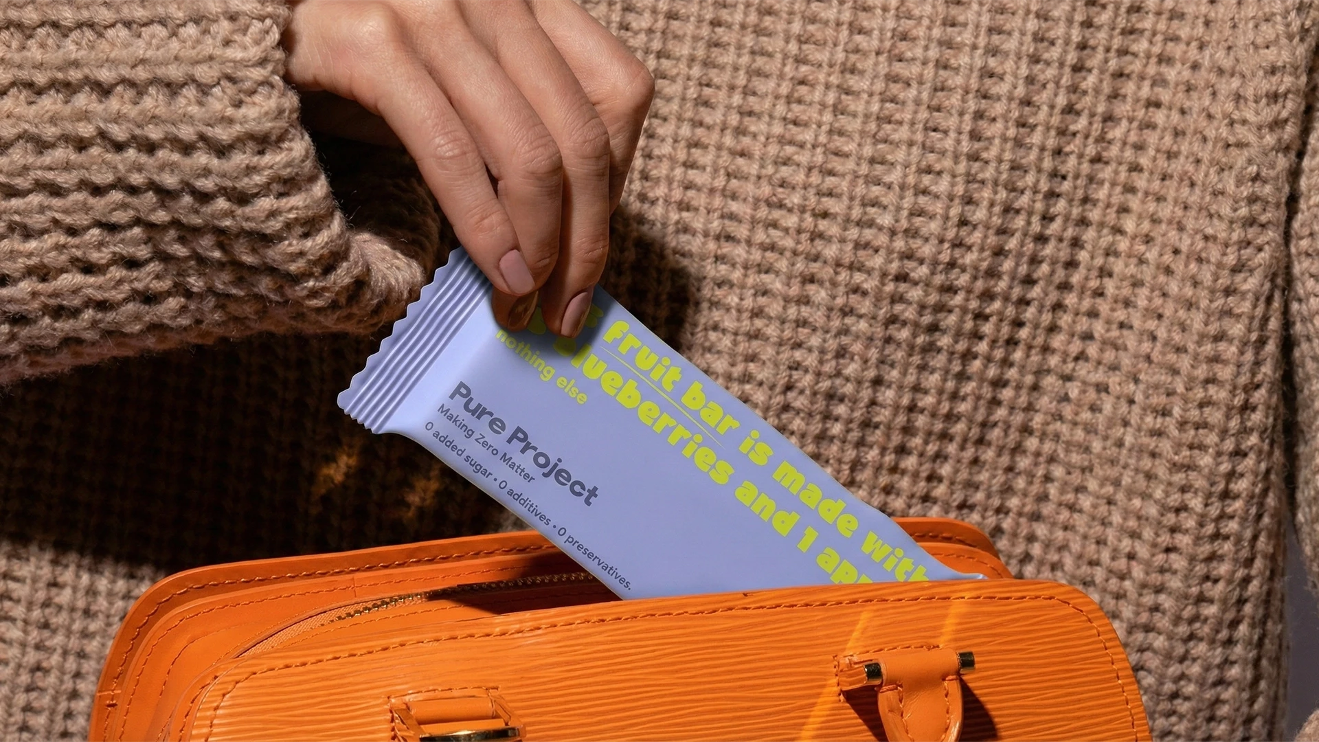 Pure Project fruit bars displayed in a natural lifestyle setting