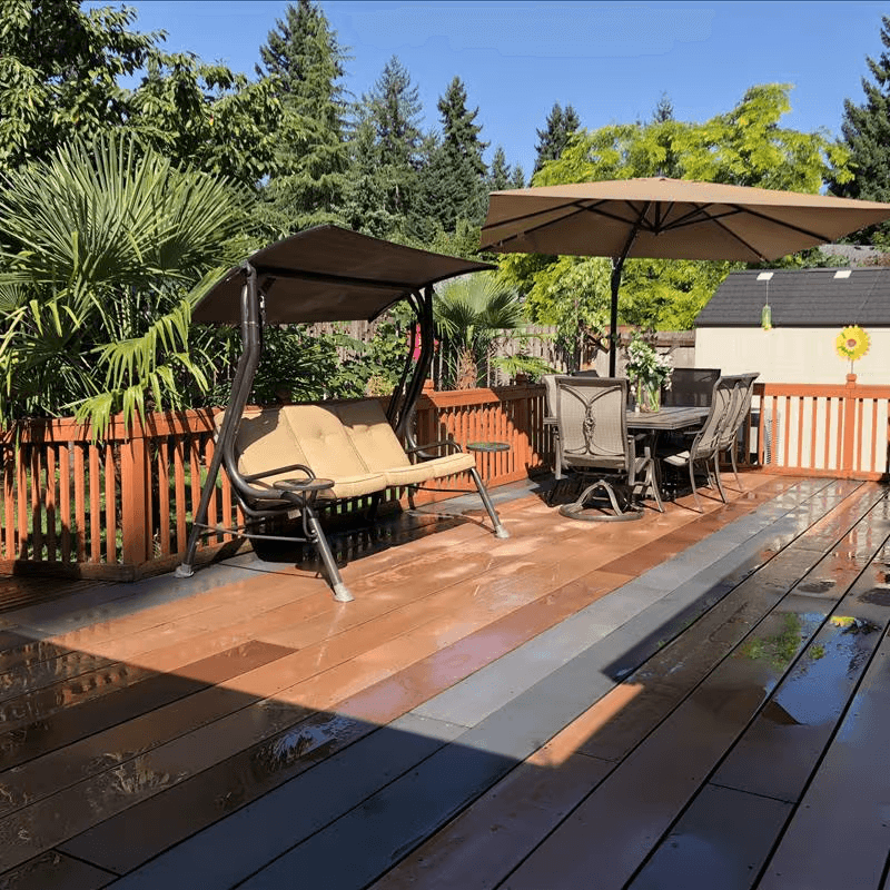 Relaxing outdoor patio at an adult family home surrounded by tropical plants and seating for residents.