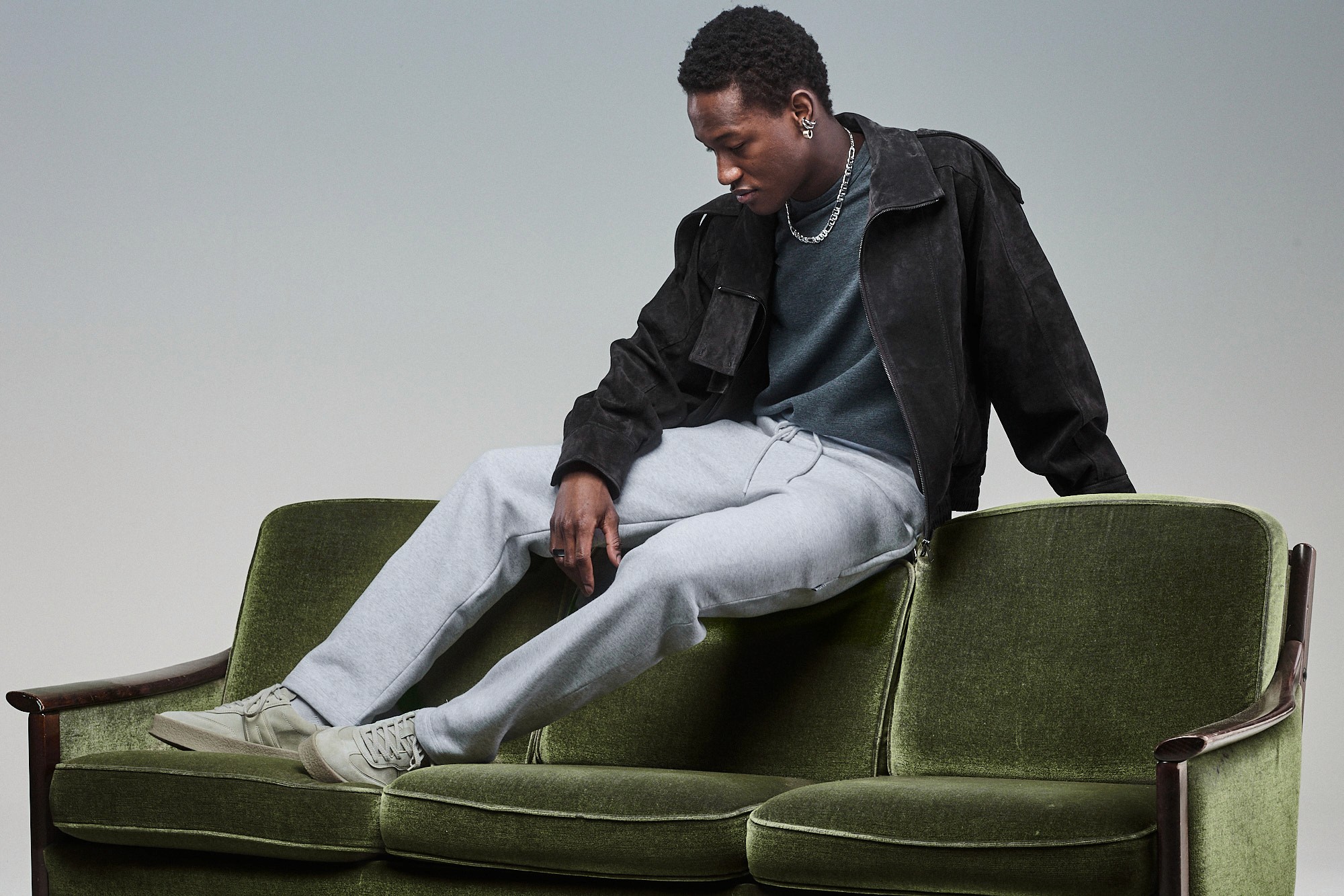 Model wearing Light grey Sunday Superior sweatpants, styled with dark outerwear