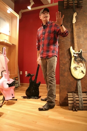 a man in a room with guitars